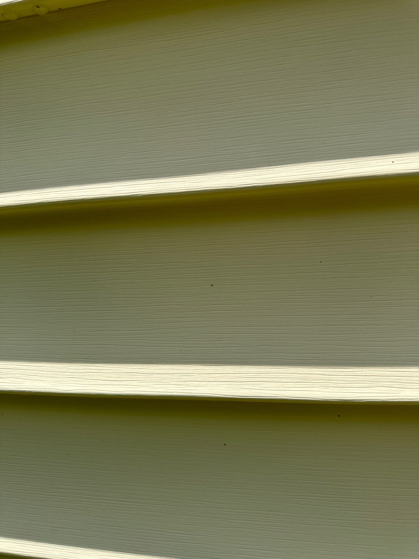 the image shows a close-up of a vinyl siding exterior the vinyl siding appears to be in good condition showing minimal dirt or wear a pressure washing company based in lancaster sc is likely providing a service that involves cleaning the exterior siding of the house they use high-pressure water spray to remove loose paint mold grime dust mud and dirt from surfaces such as buildings vehicles and concrete surfaces the result is a cleaner and more aesthetically pleasing exterior for the property