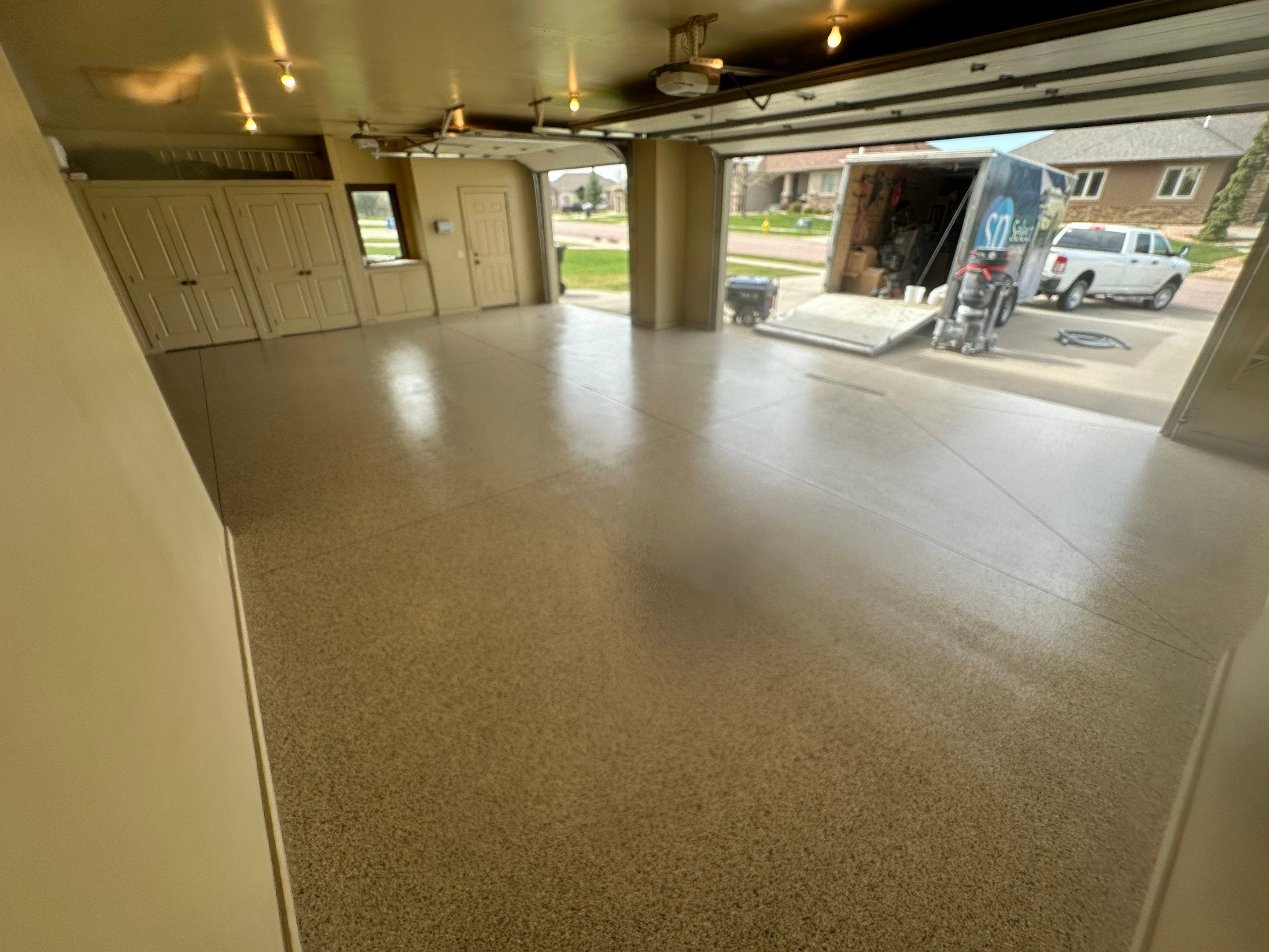 Sioux Falls Garage Floor Concrete Coating with Shoreline Flake Finish by Select Painting, Coatings & Garage Cabinets