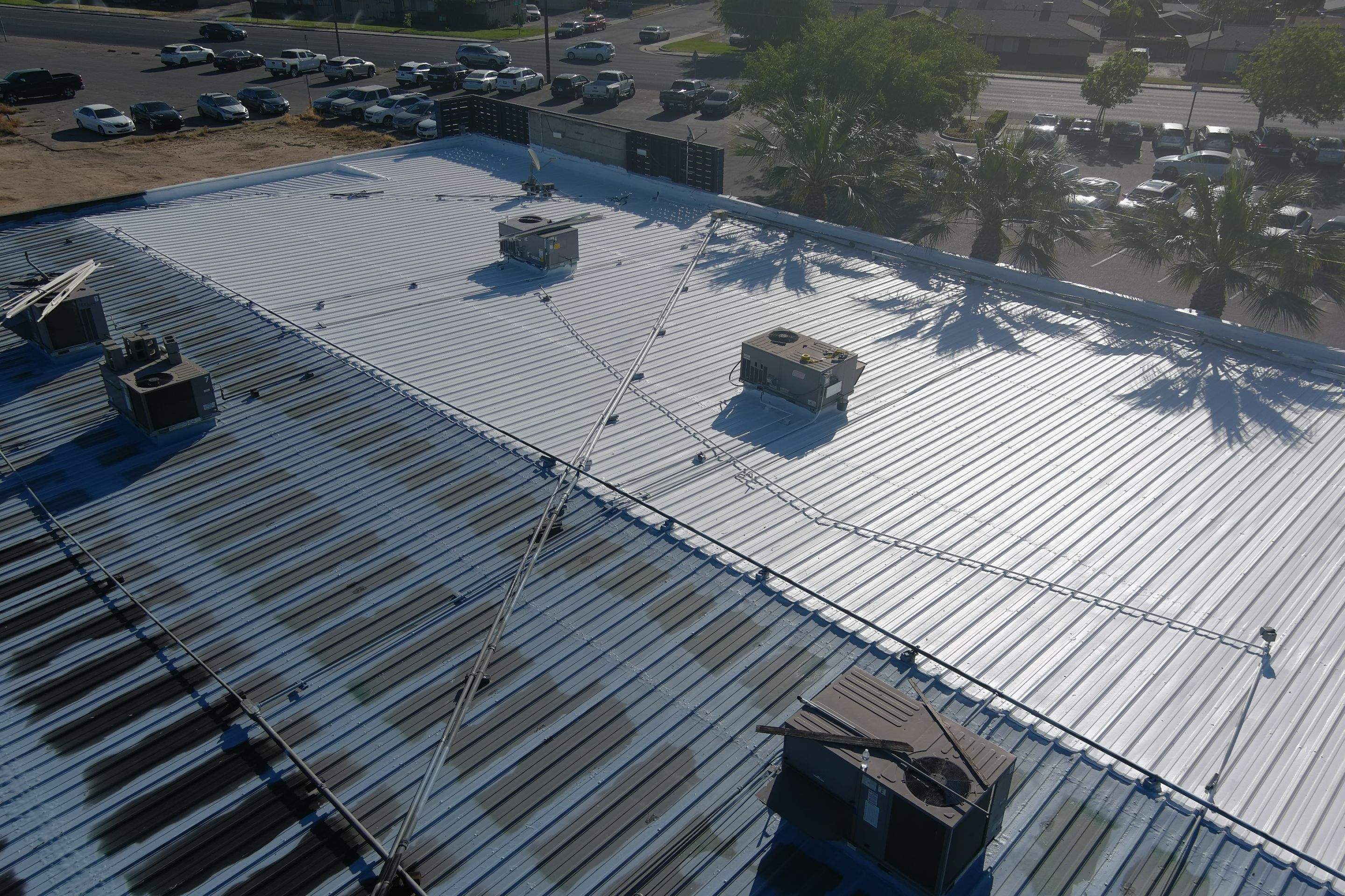 Metal roof restoration on commercial roof using Conklin Benchmark/ PUMA XL acrylic coatings over metal and foam by Straight Edge Roofing Inc