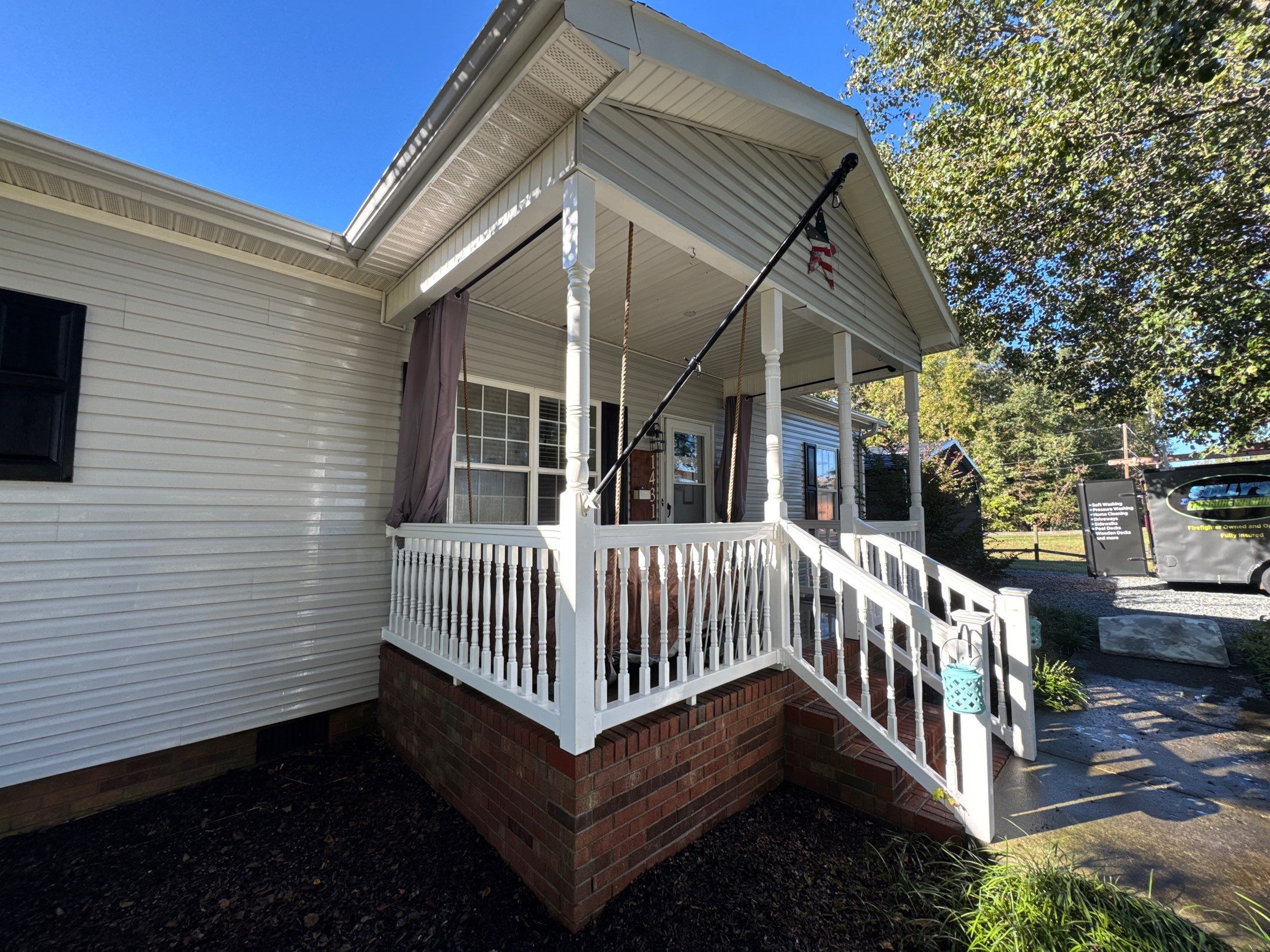 the service shows cleaning of a house exterior including siding porch and steps using pressure washing techniques