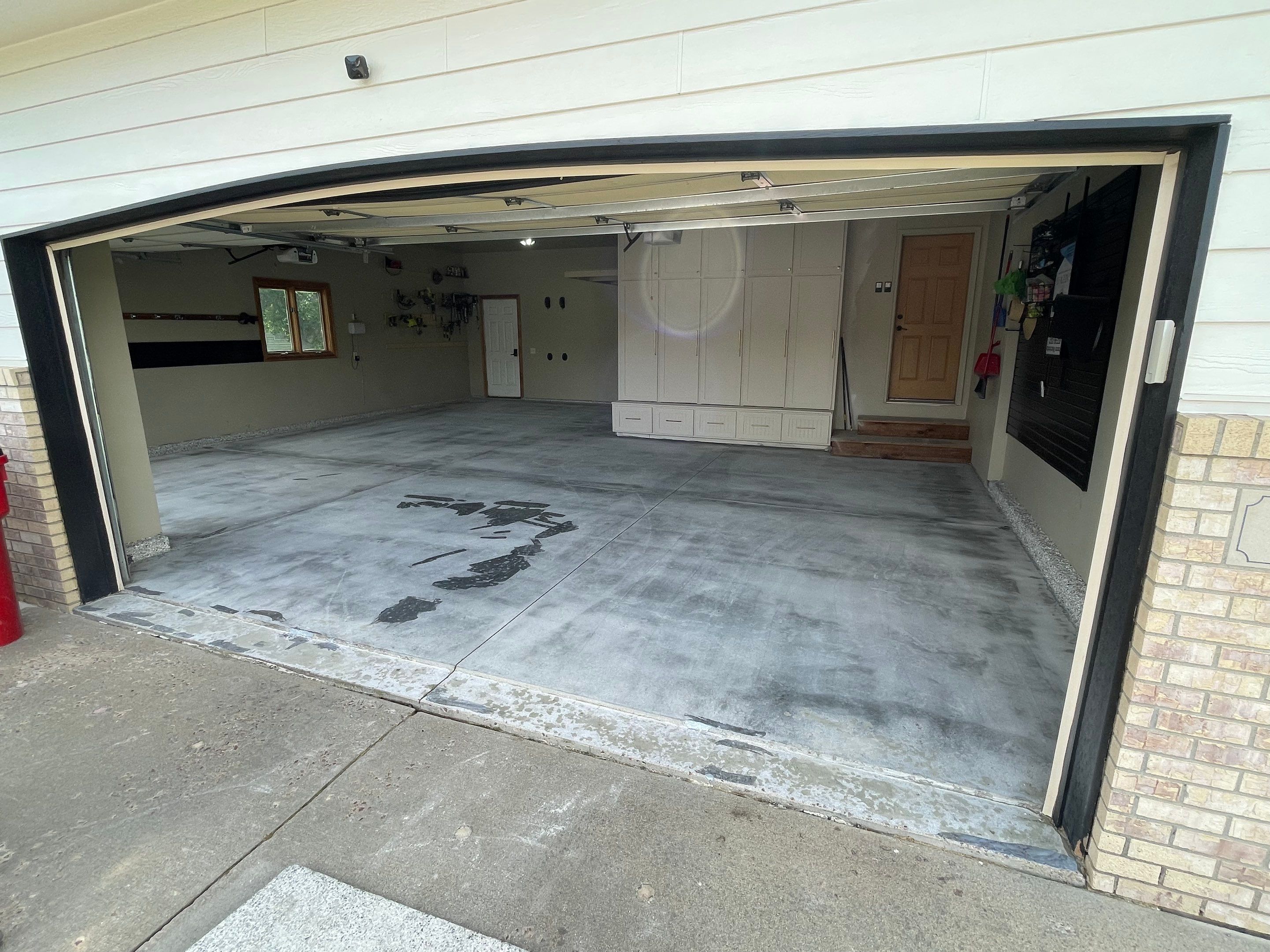 Cabin FEver Flake Garage Floor Coating Installation in Sioux Falls by Select Painting, Coatings & Garage Cabinets