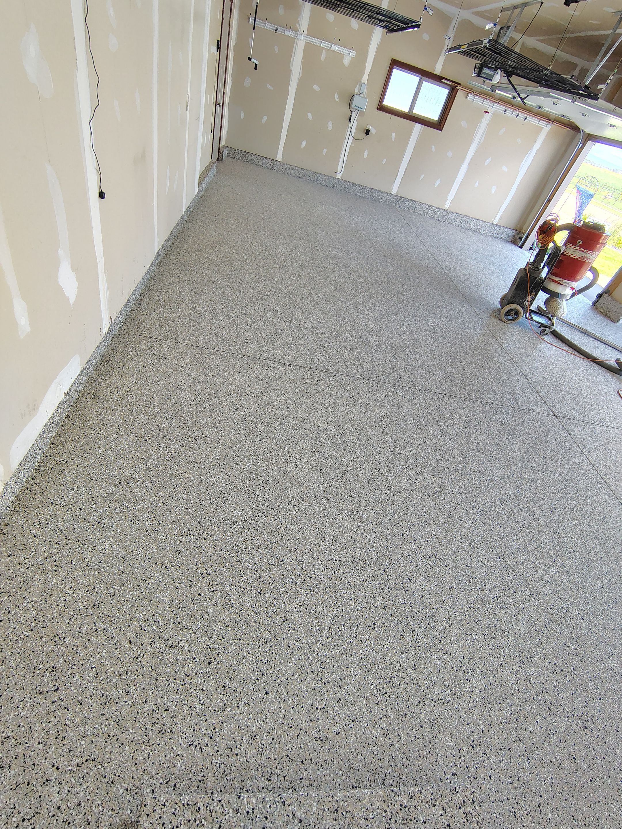 Multi-Car Garage Concrete Coating and Epoxy Finish in Sioux Falls by Select Painting, Coatings & Garage Cabinets