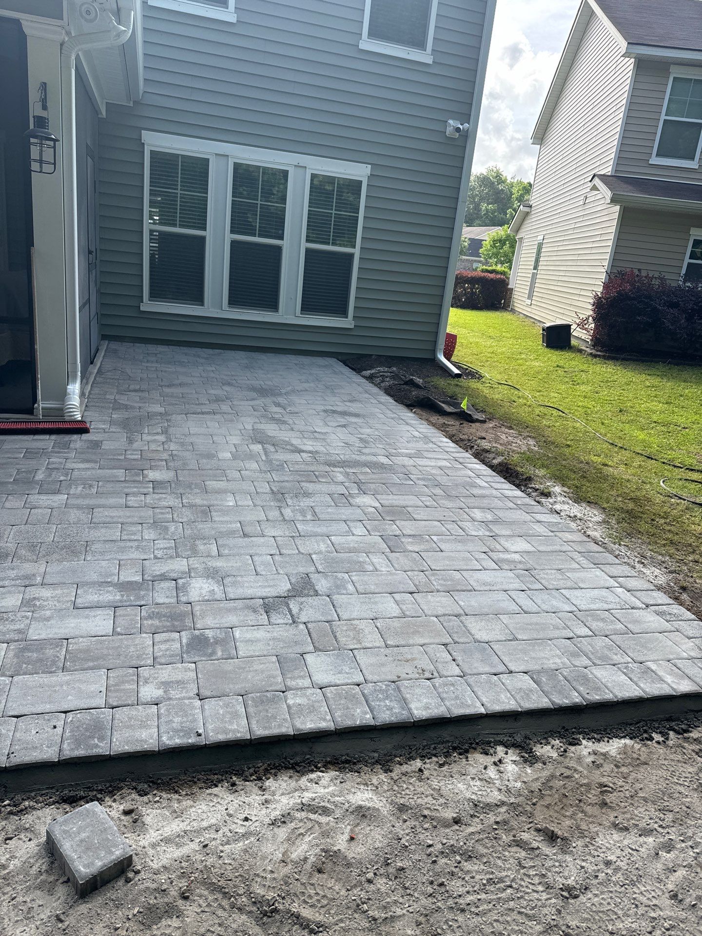 Custom Paver Patio Extension and Circular Fire Pit in Bluffton by Lowcountry Scapes, LLC