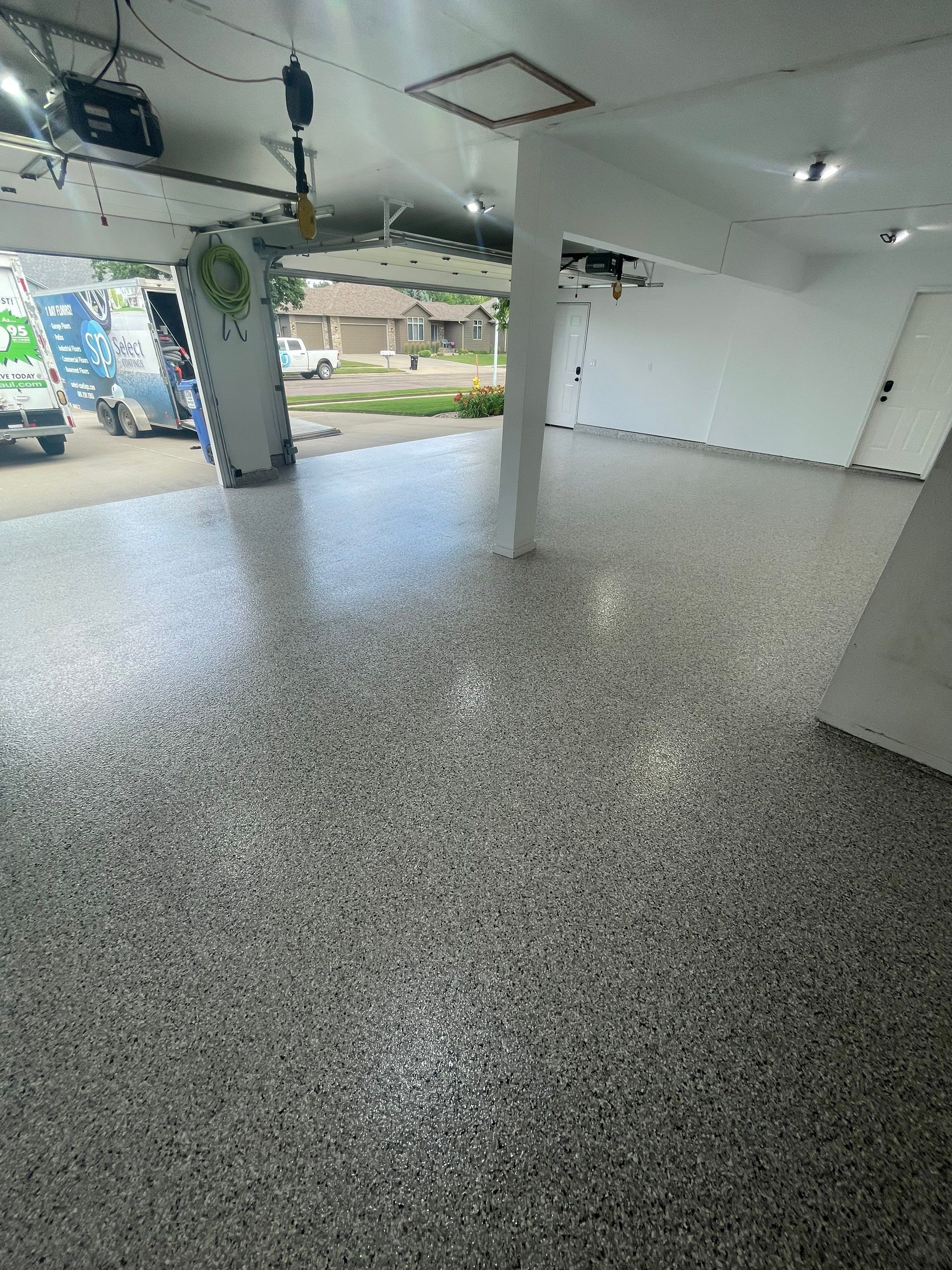 Multi-Car Garage Concrete Coating with Coyote Flake Finish in Sioux Falls by Select Painting, Coatings & Garage Cabinets