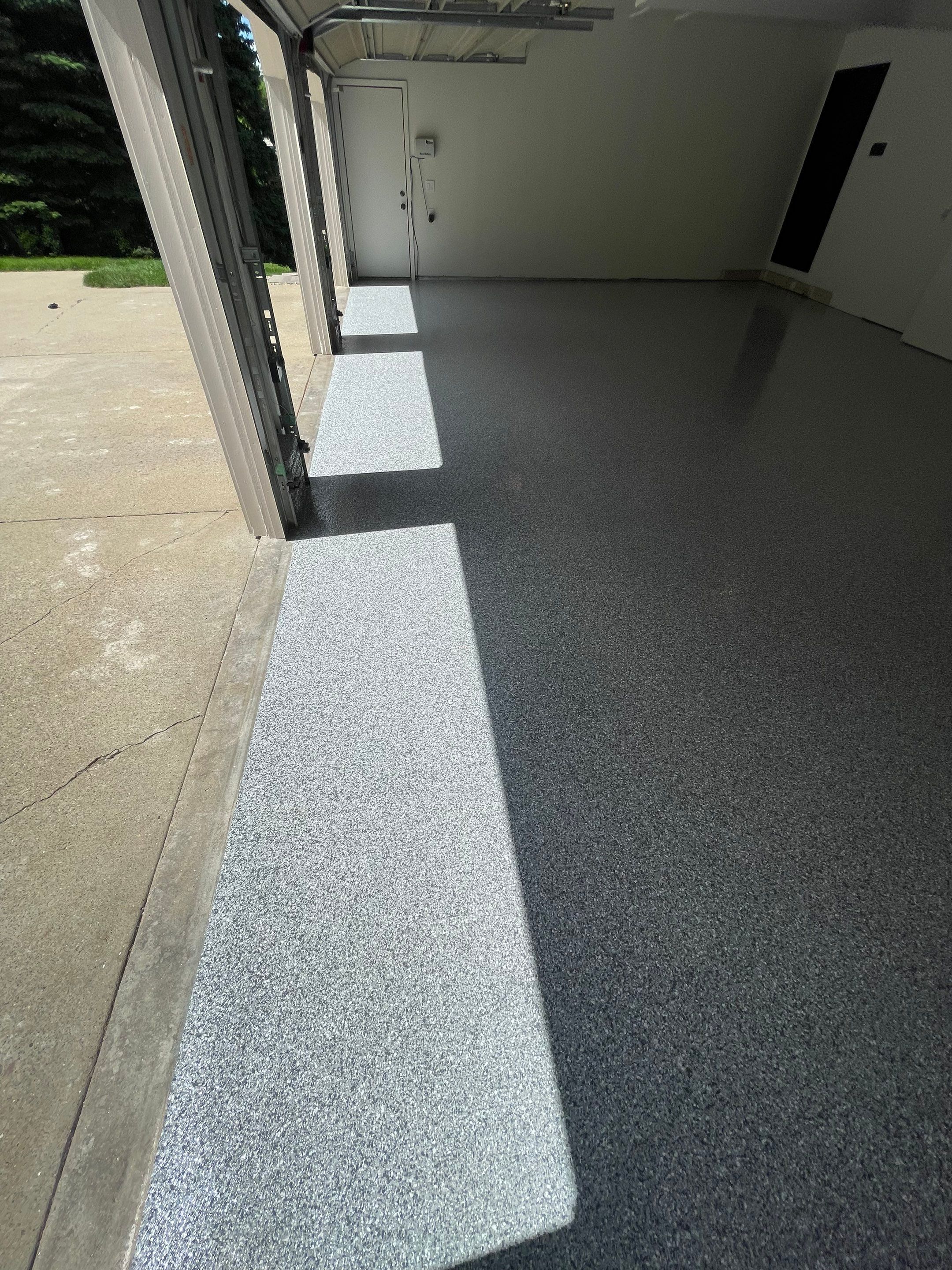 Gray Speckled Epoxy Garage Floor Coating in Sioux Falls by Select Painting, Coatings & Garage Cabinets