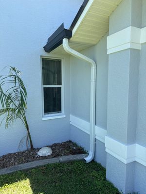 Black Seamless Gutters and White Downspouts in Cape Coral FL