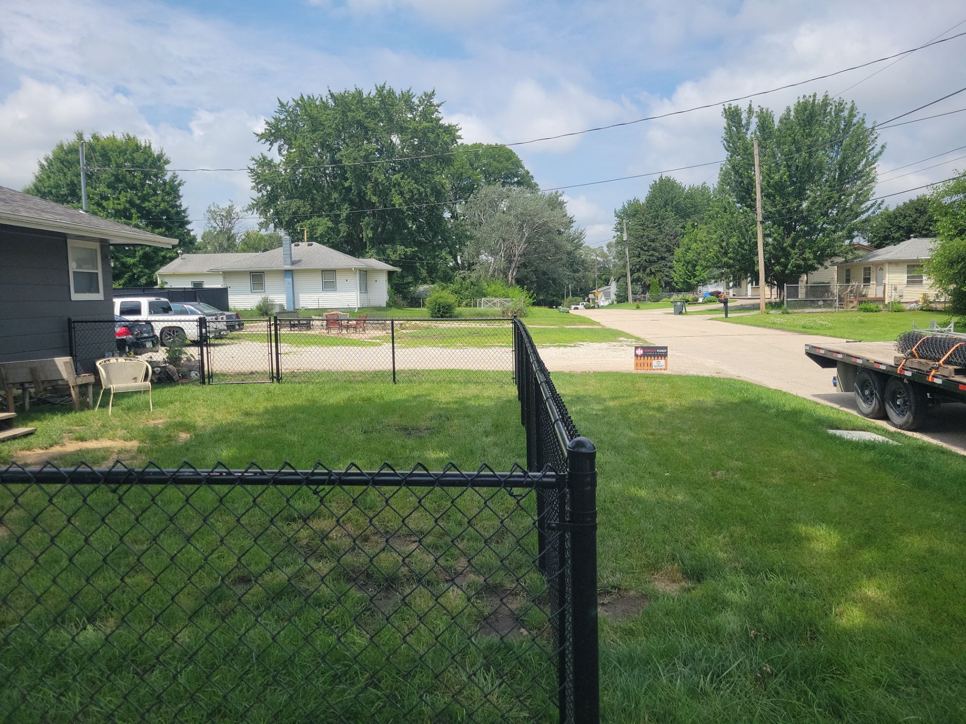 Black Chain Link Perimeter Fence Installation in Waterloo by Perfect Picket Fence and Stain