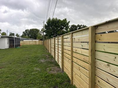 Modern Horizontal Wood Privacy Fence Installation in Fort Myers