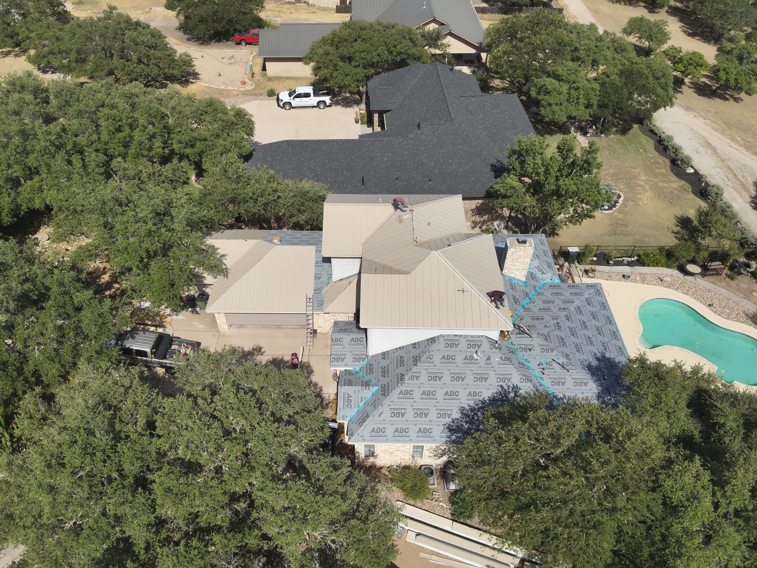 Residential Roof Replacement using 24 GA Double-Lock - Surrey Beige by Action Exteriors Austin