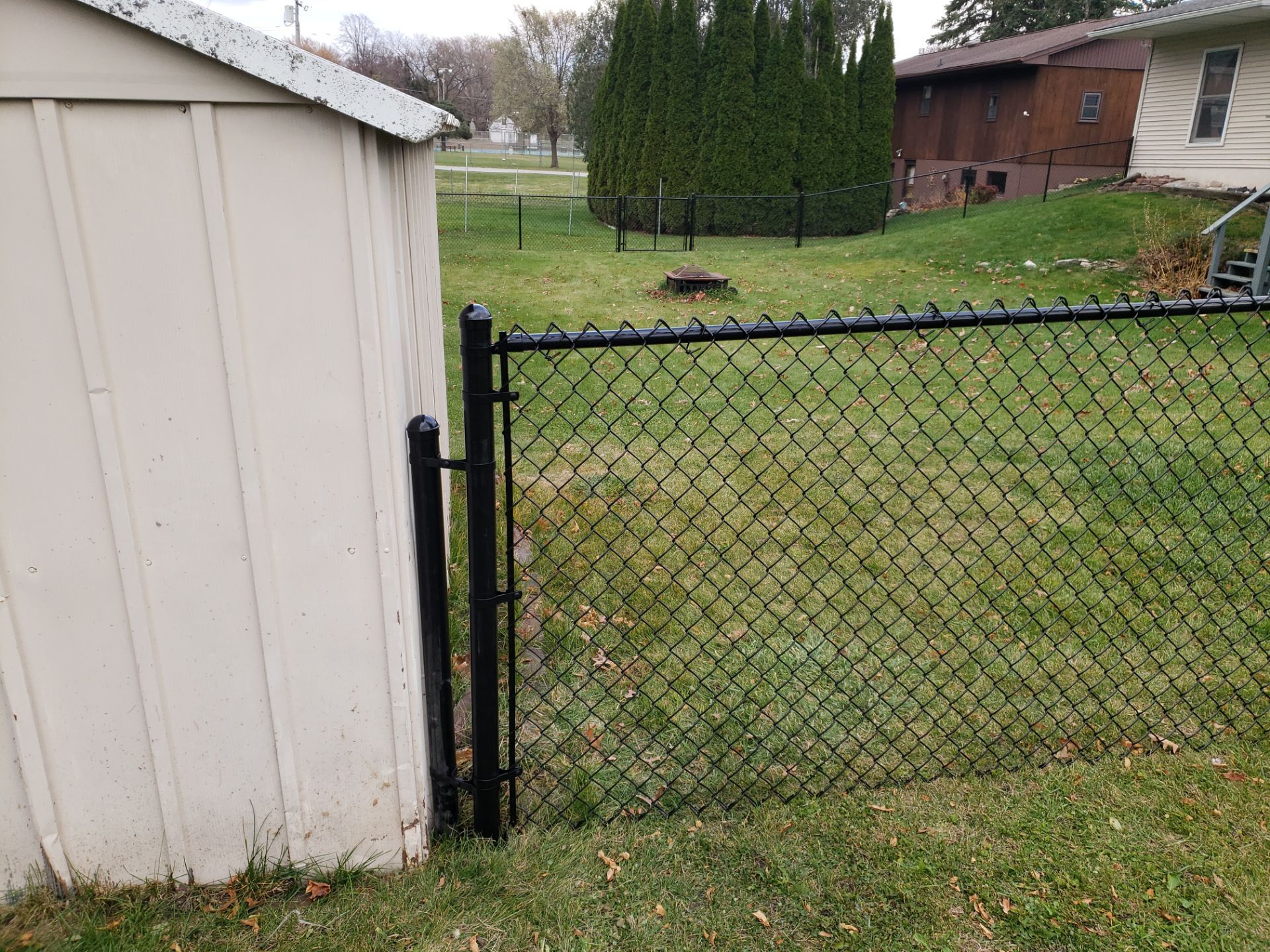 Residential Black Vinyl-Coated Chain Link Fence in Grundy Center by Perfect Picket Fence and Stain