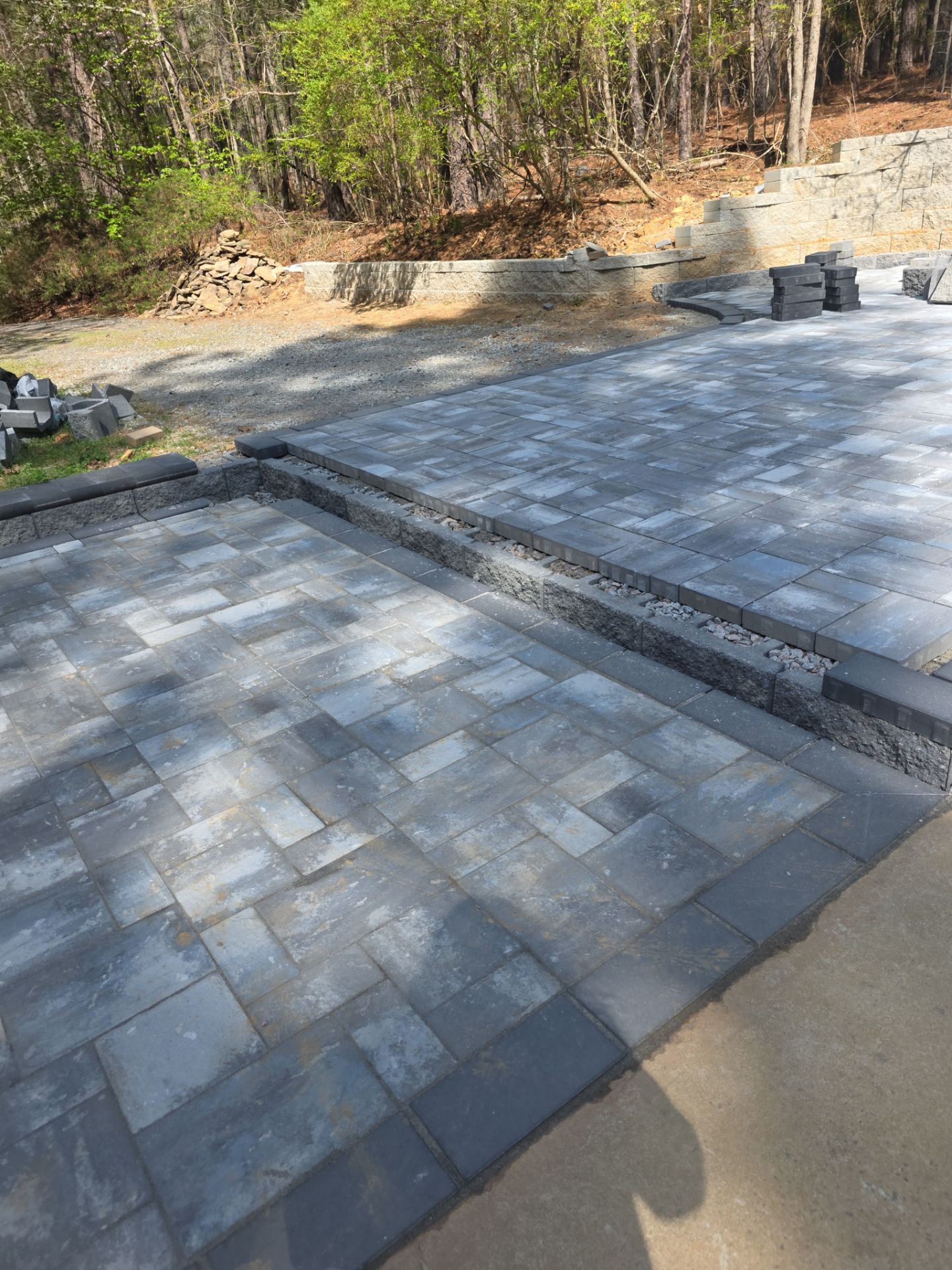 Pittsboro Outdoor Living Transformation – Retaining Wall, Paver Patio & Elevated Deck by Elite Remodeling and Design LLC