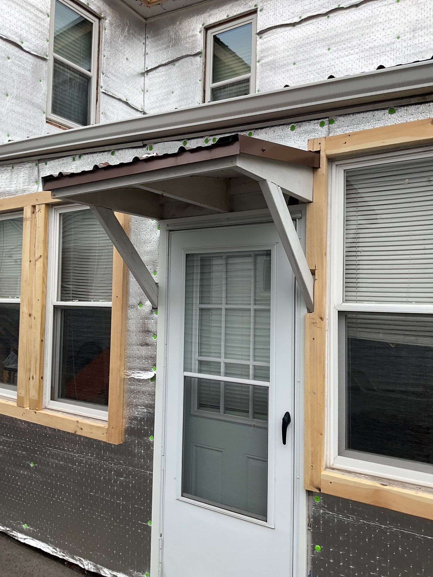 Exterior Renovation with Vinyl Siding, Metal Roof & Spouting  by Esh Builders