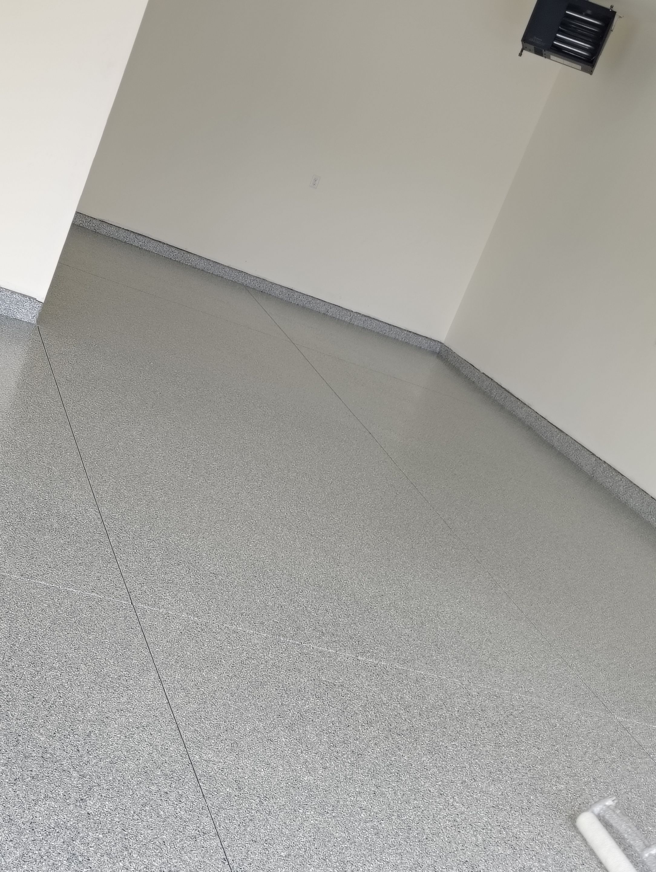 Sioux Falls Garage Floor Transformation with Gray Decorative Flake Coating by Select Painting, Coatings & Garage Cabinets