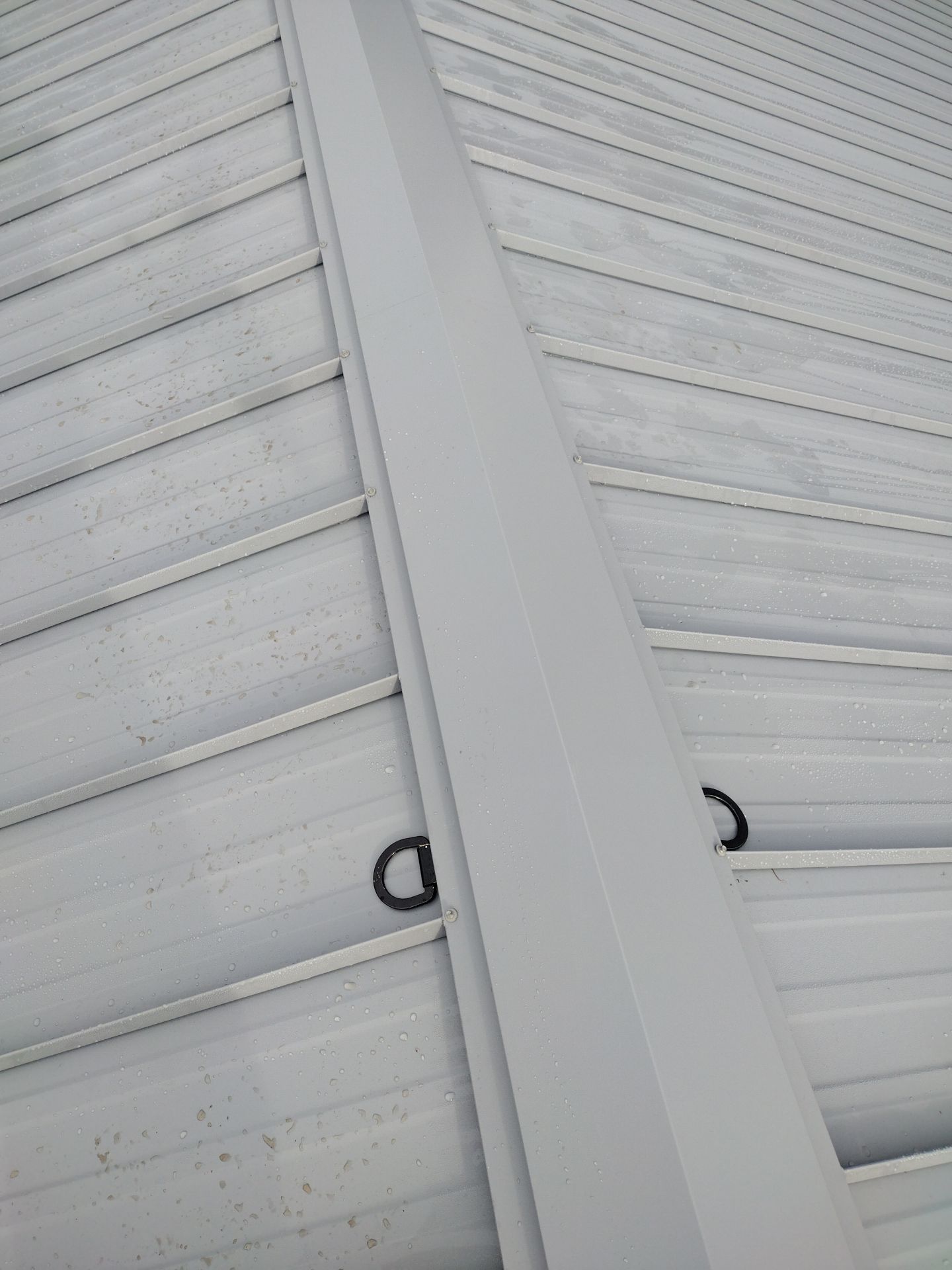 Grey Habitat for Humanity Metal Roof by Orezona Building & Roofing Company, Inc.