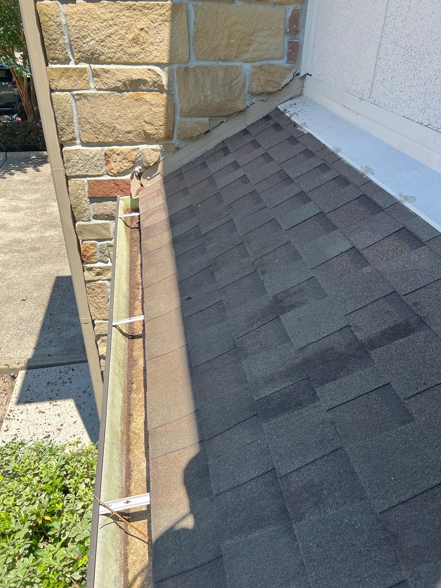 HOA gutter cleaning in League City & Webster, after  photo showing full gutters.