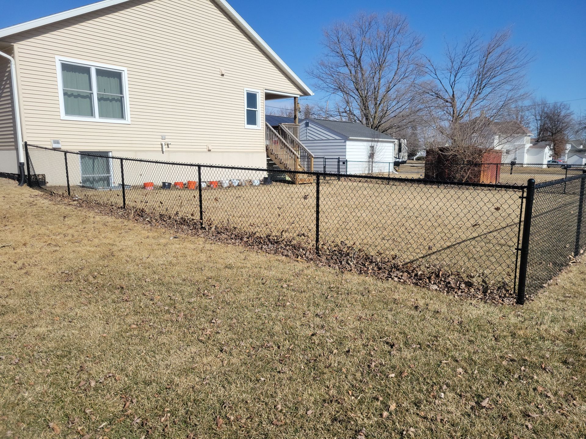 Residential Black Chain Link Fence and Gate Installation in Tripoli by Perfect Picket Fence and Stain