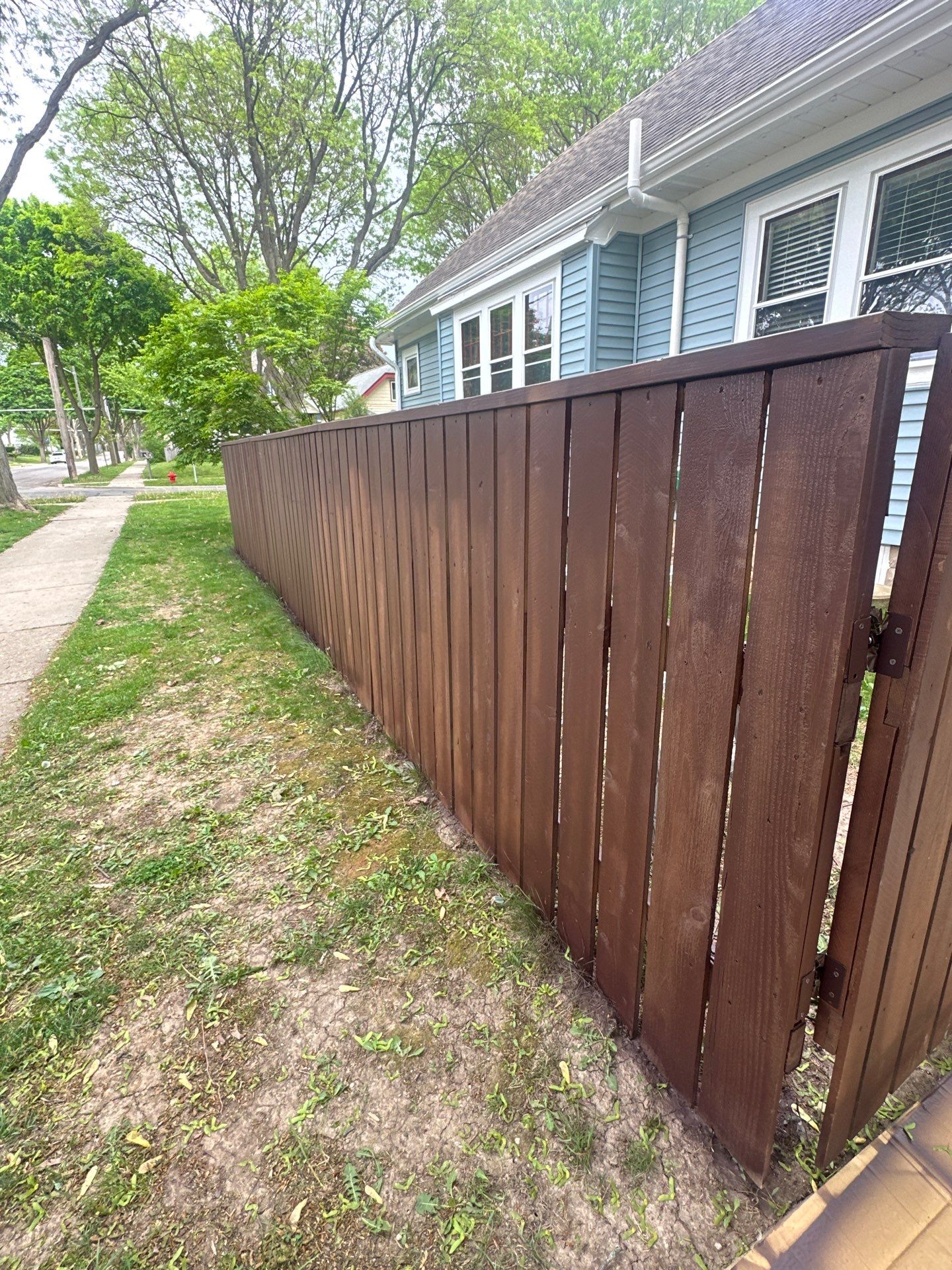 Exterior Porch Restoration and Privacy Fence Staining in Wauwatosa by OCS Contracting Services