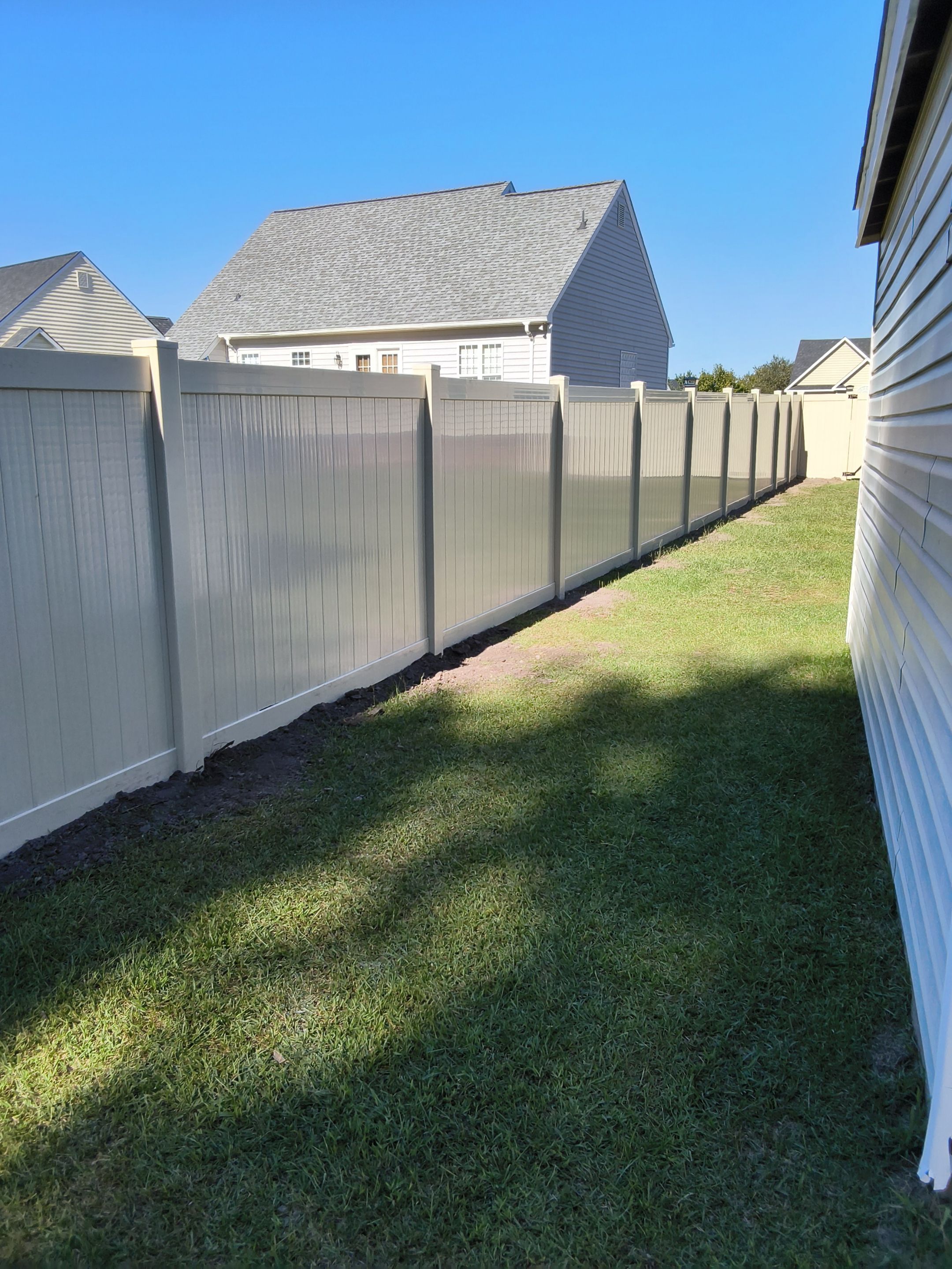 Custom Tan Vinyl Privacy Fence Installation with Double Gates in Winterville by Superior Fence and Rail