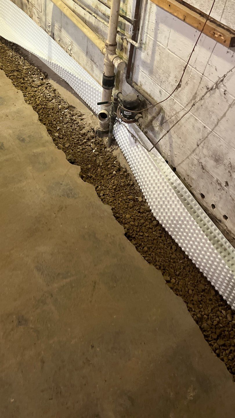 Interior drain tile system installation by ACE Waterproofing & Basement Solutions