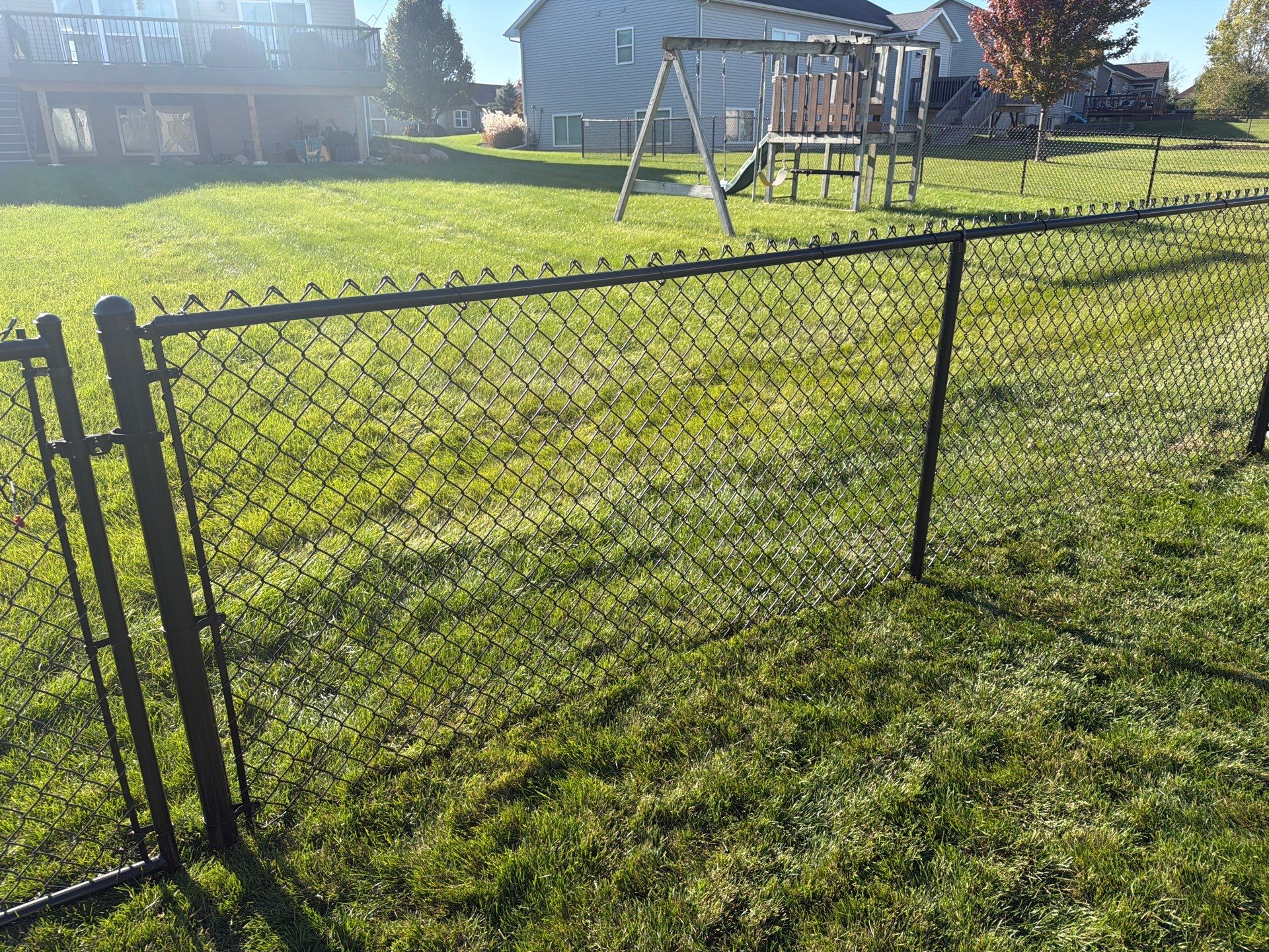 Black Vinyl-Coated Chain Link Fence Installation in Cedar Falls by Perfect Picket Fence and Stain