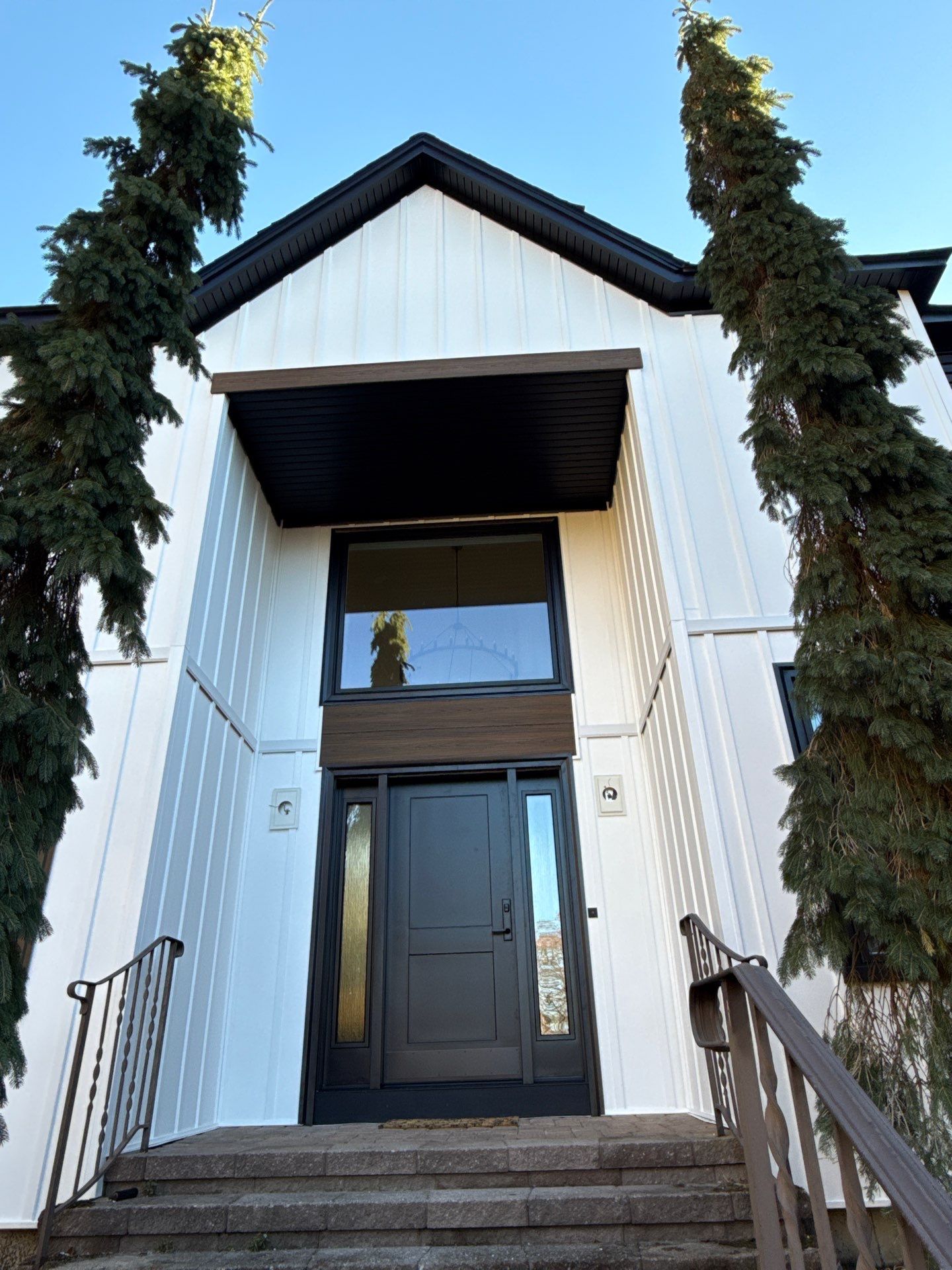 Bold Siding transformation with Cert Cedar Board & Batten S12, White, and Cert Monogram D/4 x 12'6" clapboard, Tuxedo by DiGiorgi Roofing and Siding Inc