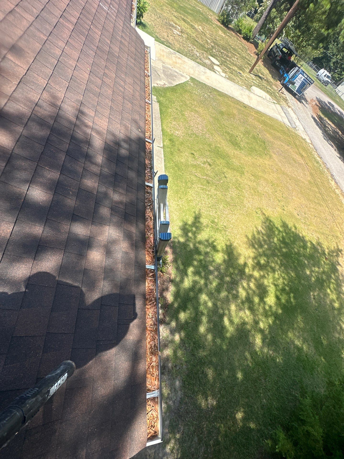 gutter cleaning is being done by lancaster pro wash on a house in lancaster south carolina