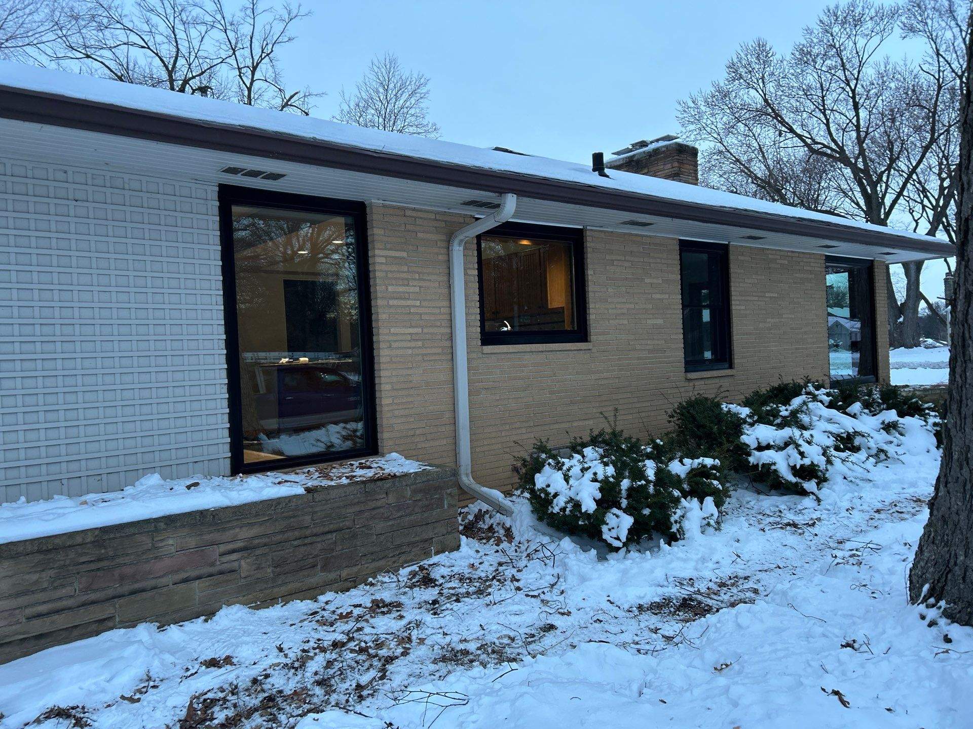 Black-Frame Pella Lifestyle Upgrade on a Partial Brick Home by United Windows and Siding LLC