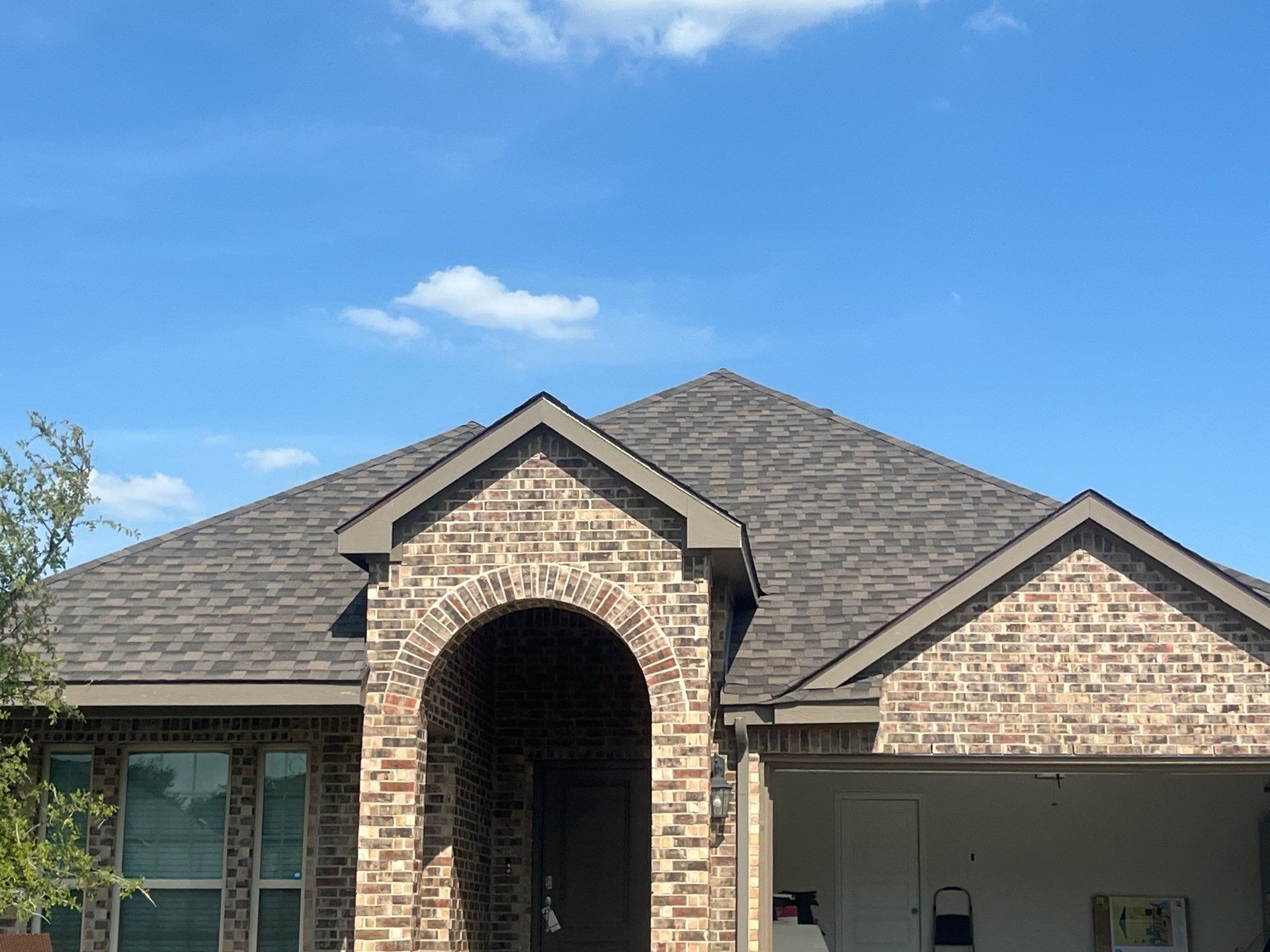 Medium brown brick with IKO Driftshake by Tejas Roofworks + Restoration