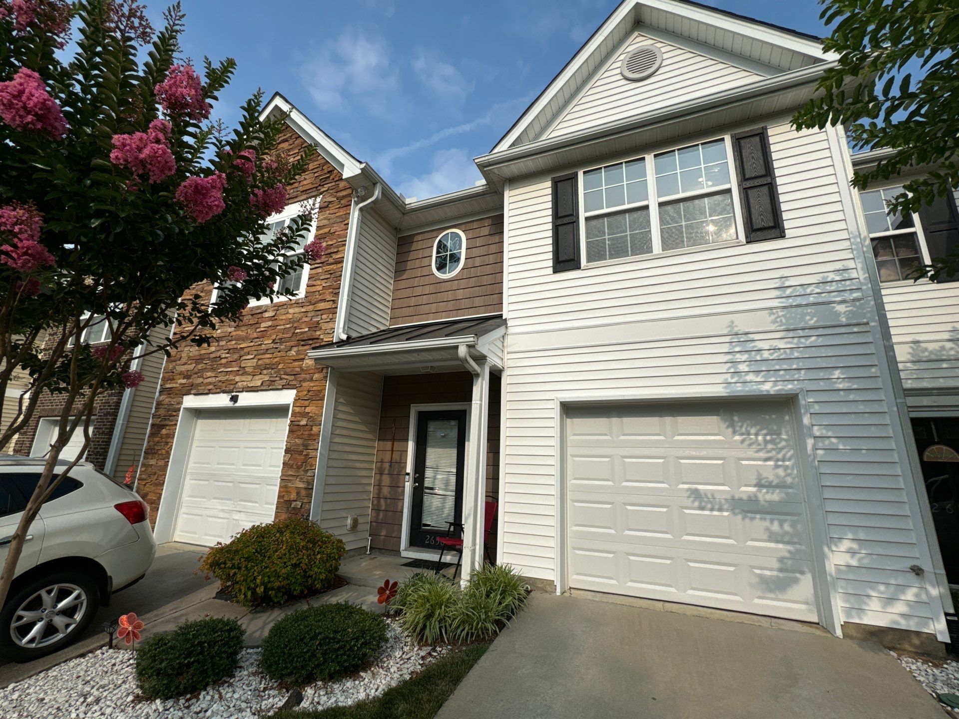 pressure washing exterior siding driveway and garage door surfaces to remove dirt and grime for a clean appearance