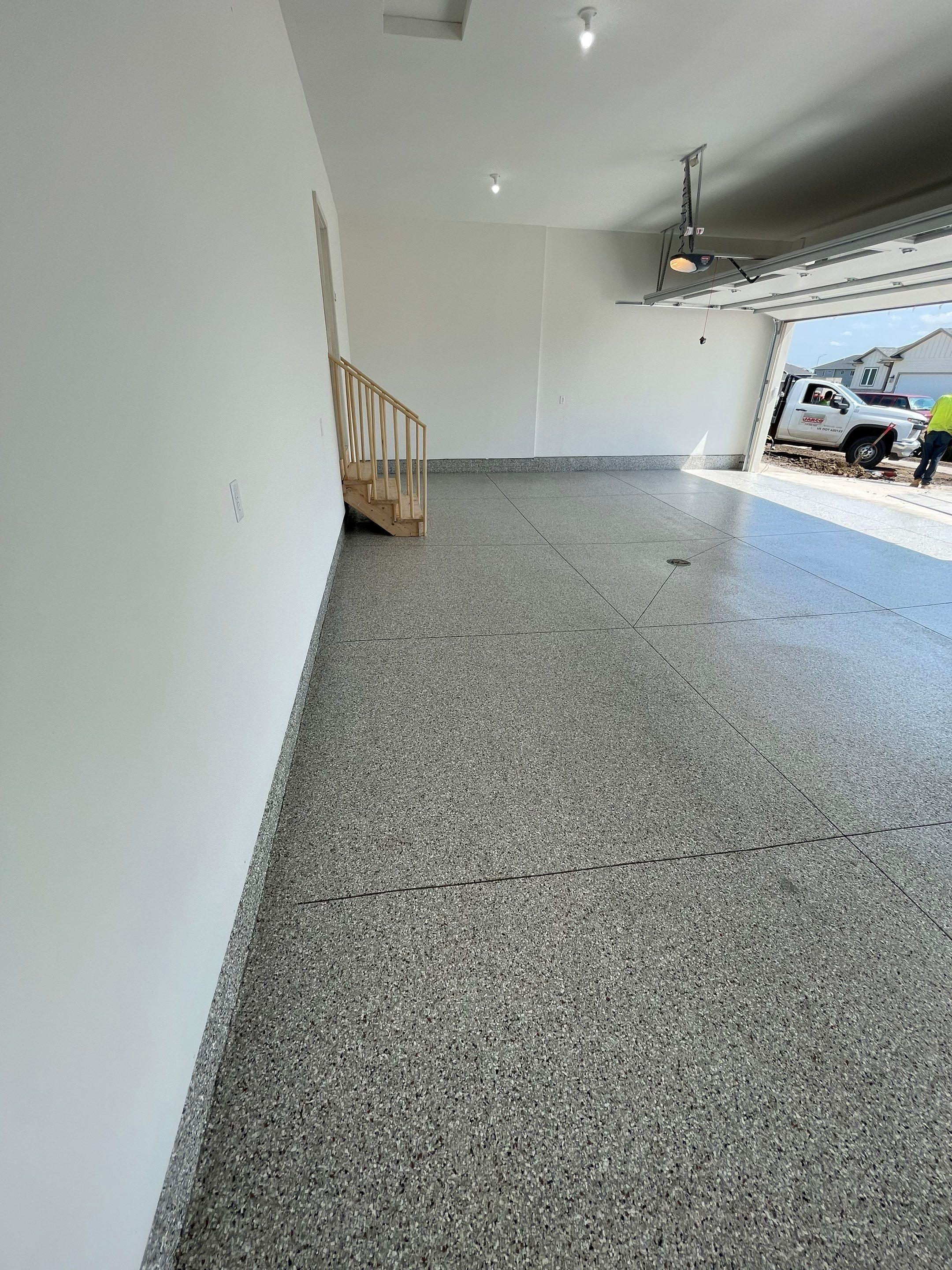 Grey Speckled Garage Floor Coating in Sioux Falls by Select Painting, Coatings & Garage Cabinets