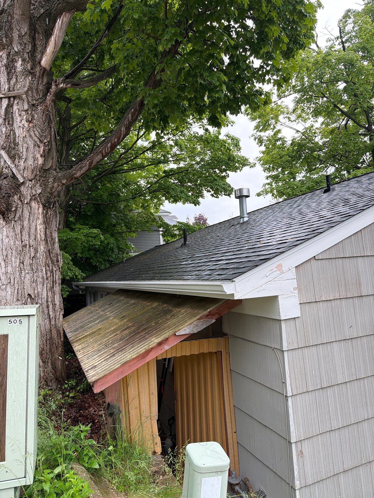 White Gutter and Downspout System Installation in Petoskey by Rainbow Seamless Systems