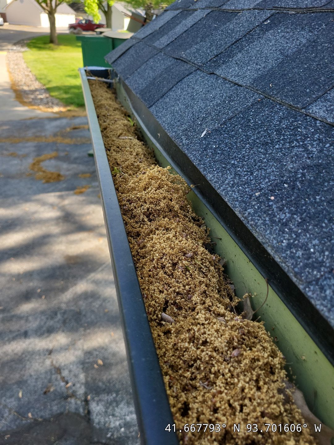 Commercial gutter cleaning Ames, IA before photo with filled gutters