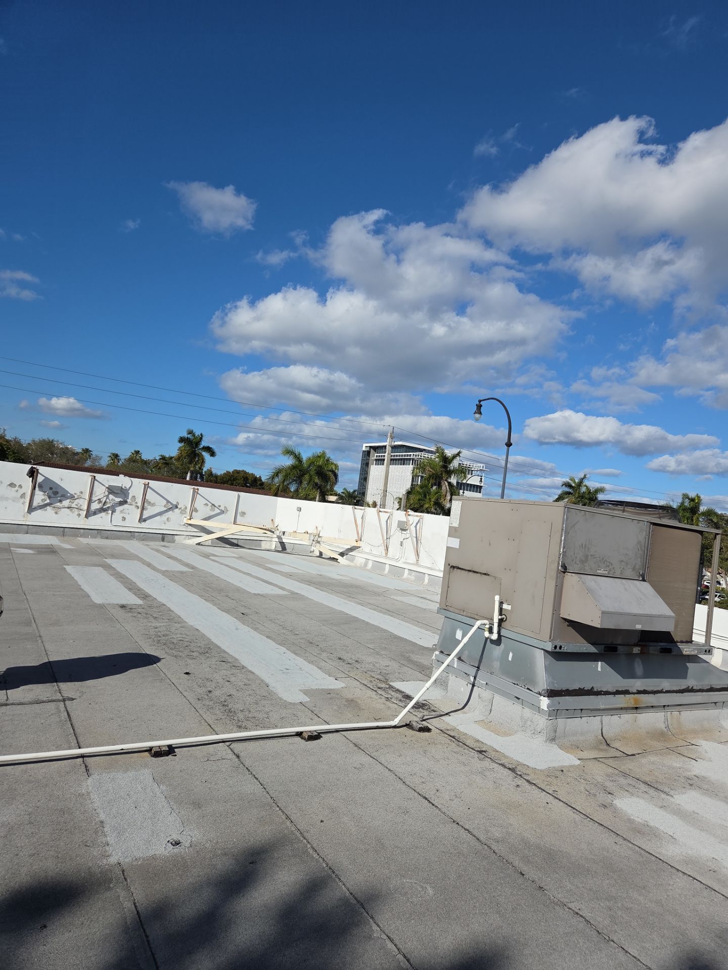 Commercial Flat Roof Restoration Using Silicone Coating in Hallandale Beach by Aastro Roofing