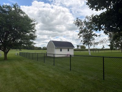 Black Vinyl-Coated Chain Link Fence Installation in Fairbank
