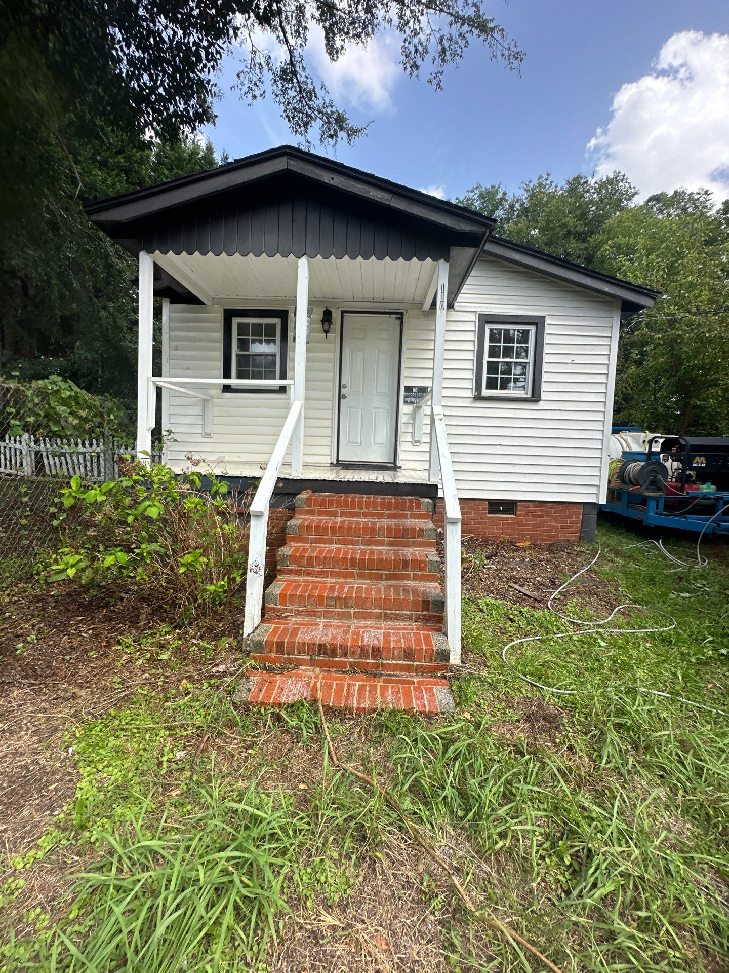 cleaning of brick steps and exterior walls of the house using pressure washing techniques to remove dirt and grime