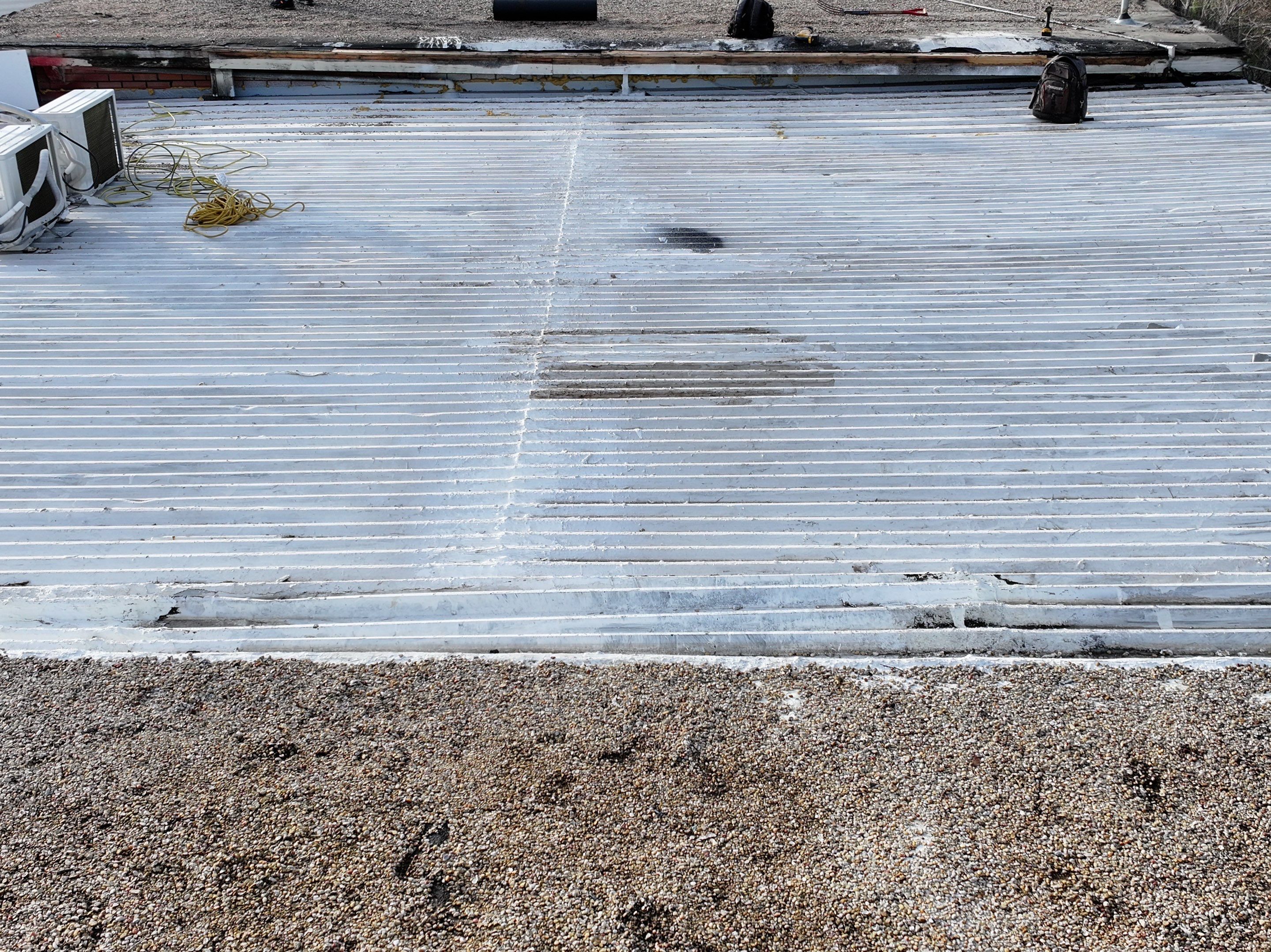 Commercial roofing overlay using GAF TPO over an old ballast roof by Becker Roofing and Exteriors