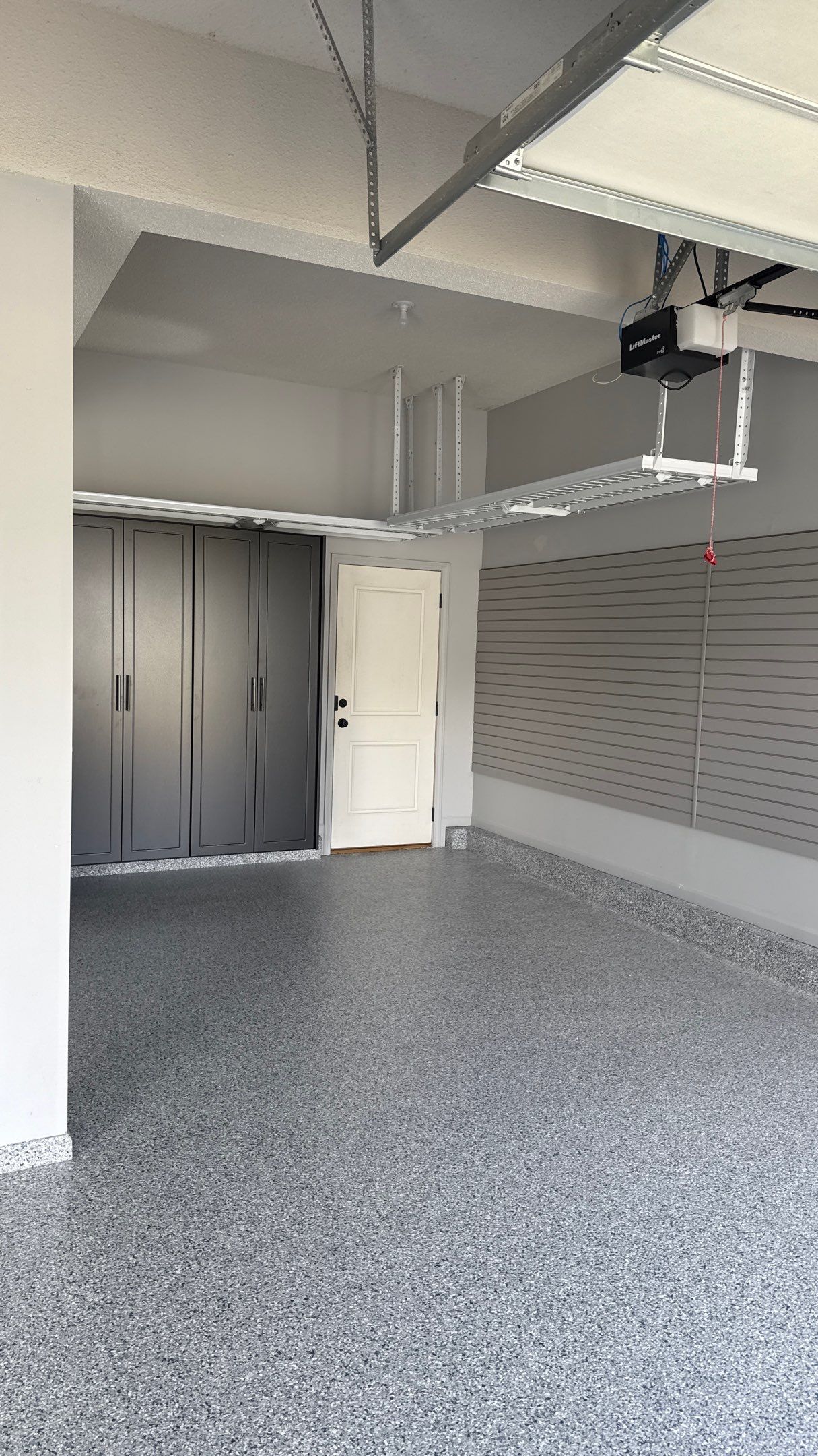Comprehensive Garage Renovation Featuring Epoxy Flooring and Custom Storage in Shawnee by Banner Garage
