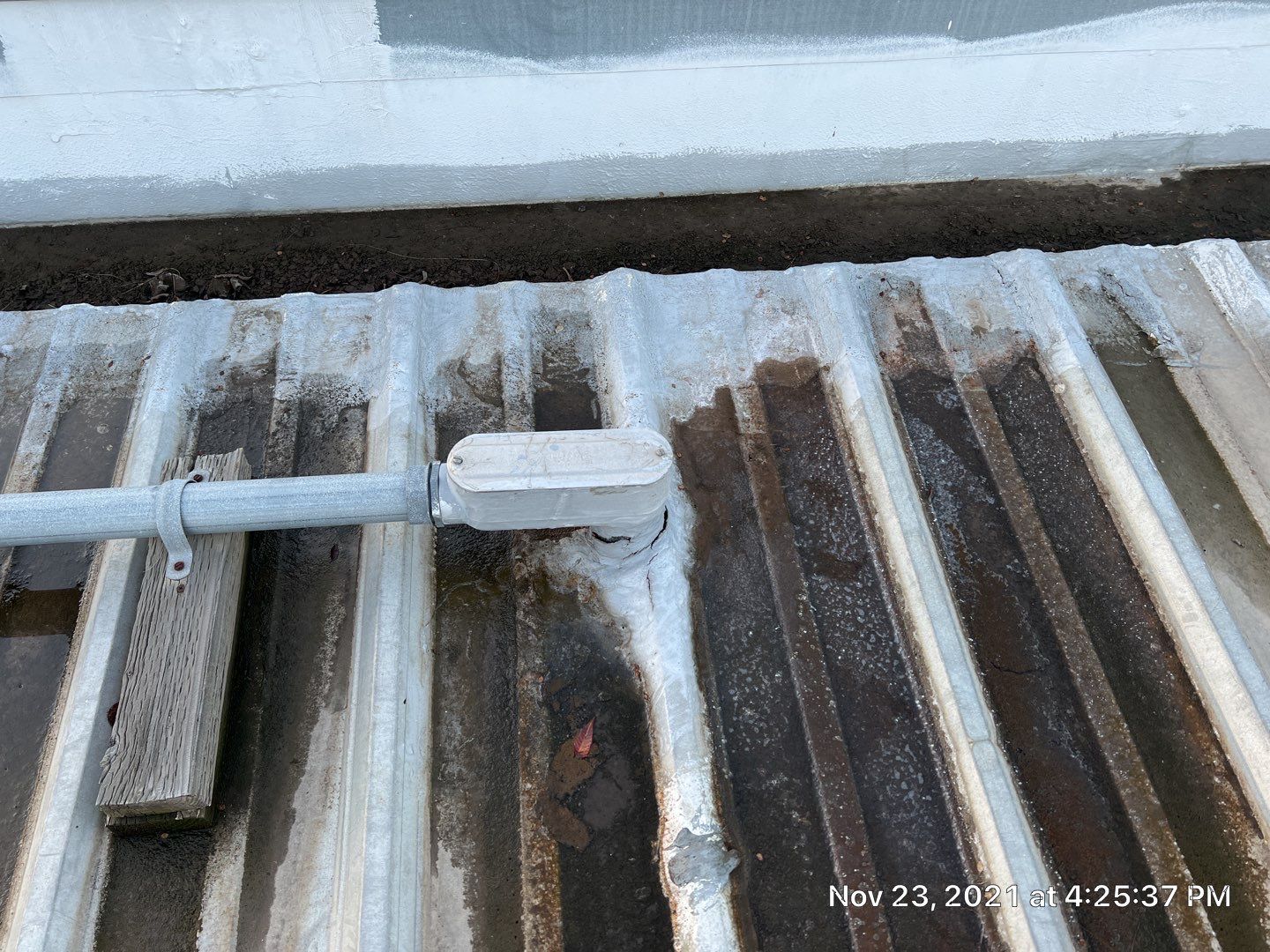 Metal roof restoration on commercial roof using Conklin Benchmark/ PUMA XL acrylic coatings over metal and foam by Straight Edge Roofing Inc