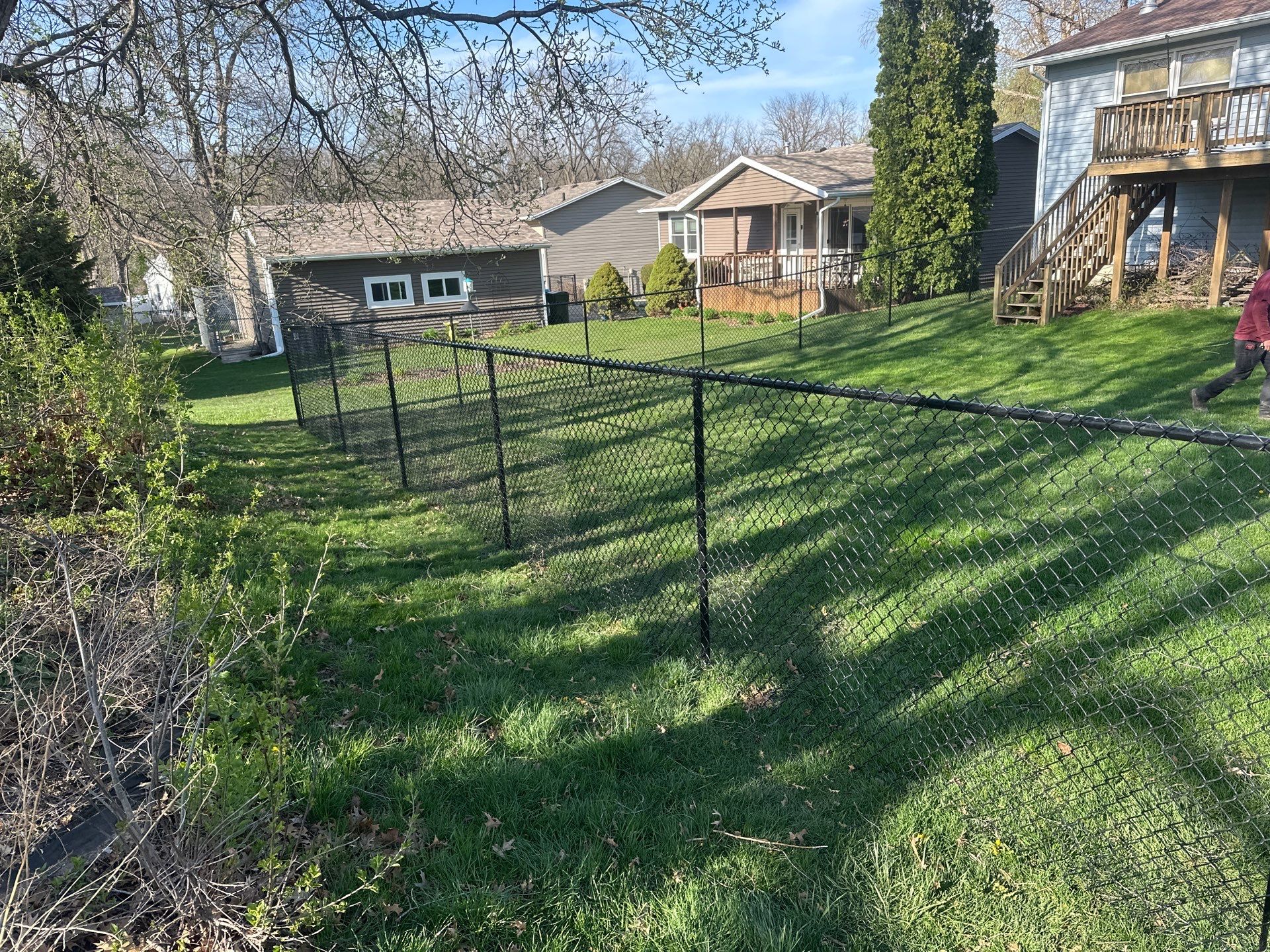 Black Vinyl-Coated Chain Link Fence Installation in Waterloo by Perfect Picket Fence and Stain
