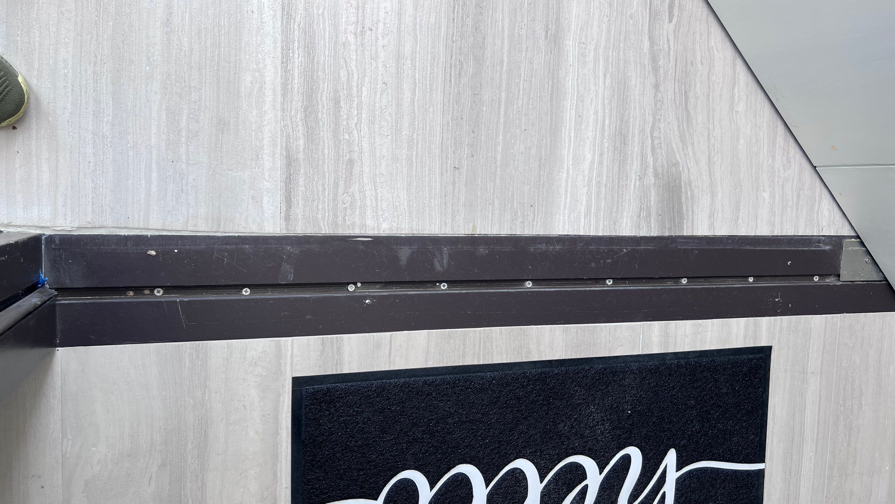 Custom Material Pivot Door installation by Impact Precious Wood Inc.