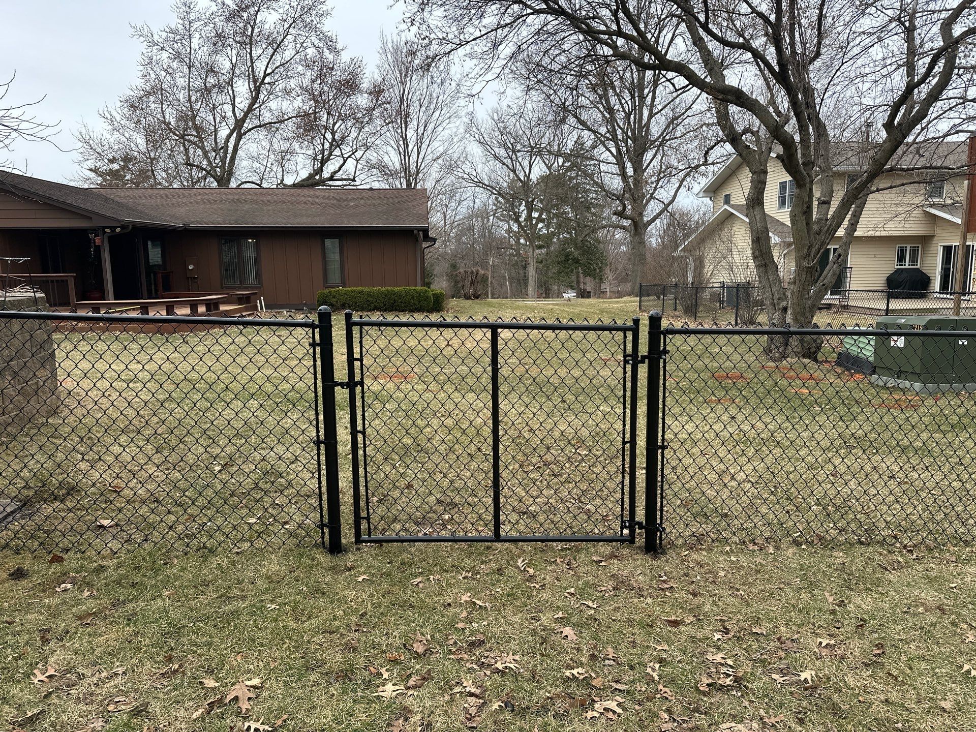 Black Vinyl Chain Link Fence Installation in Cedar Falls by Perfect Picket Fence and Stain