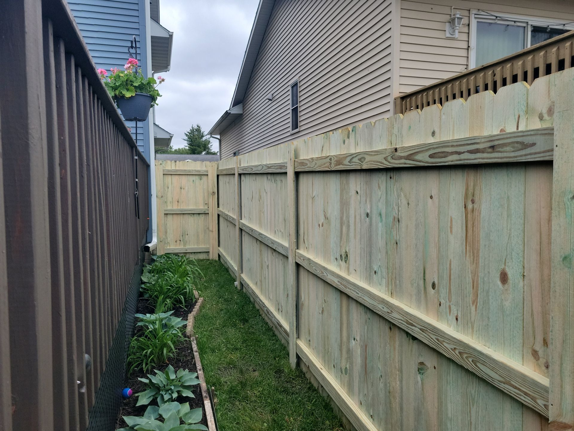 Pressure-Treated Wood Privacy Fence Installation in Waterloo by Perfect Picket Fence and Stain