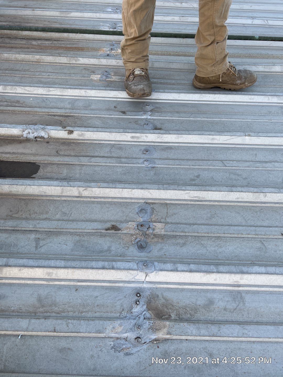 Metal roof restoration on commercial roof using Conklin Benchmark/ PUMA XL acrylic coatings over metal and foam by Straight Edge Roofing Inc