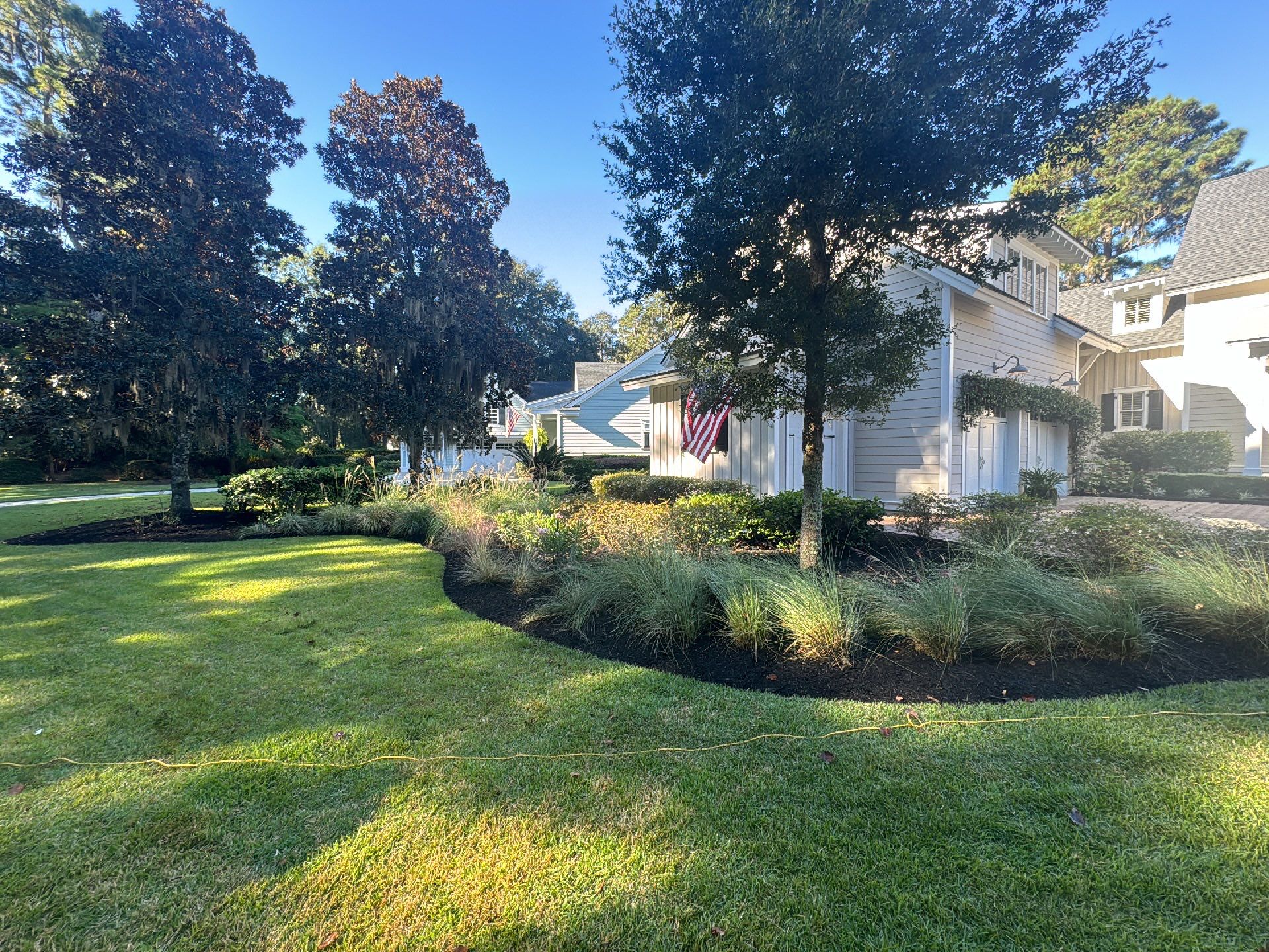 Herringbone Brick Paver Driveway and Custom Landscape Installation in Bluffton by Lowcountry Scapes, LLC