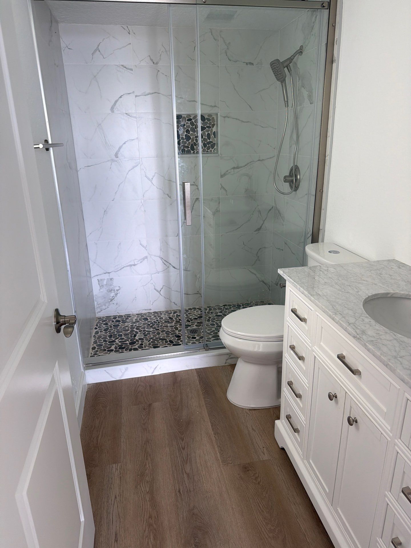 Full Condominium Remodel Featuring Aubrey Oak Flooring In Daytona Beach by Acies Renovations