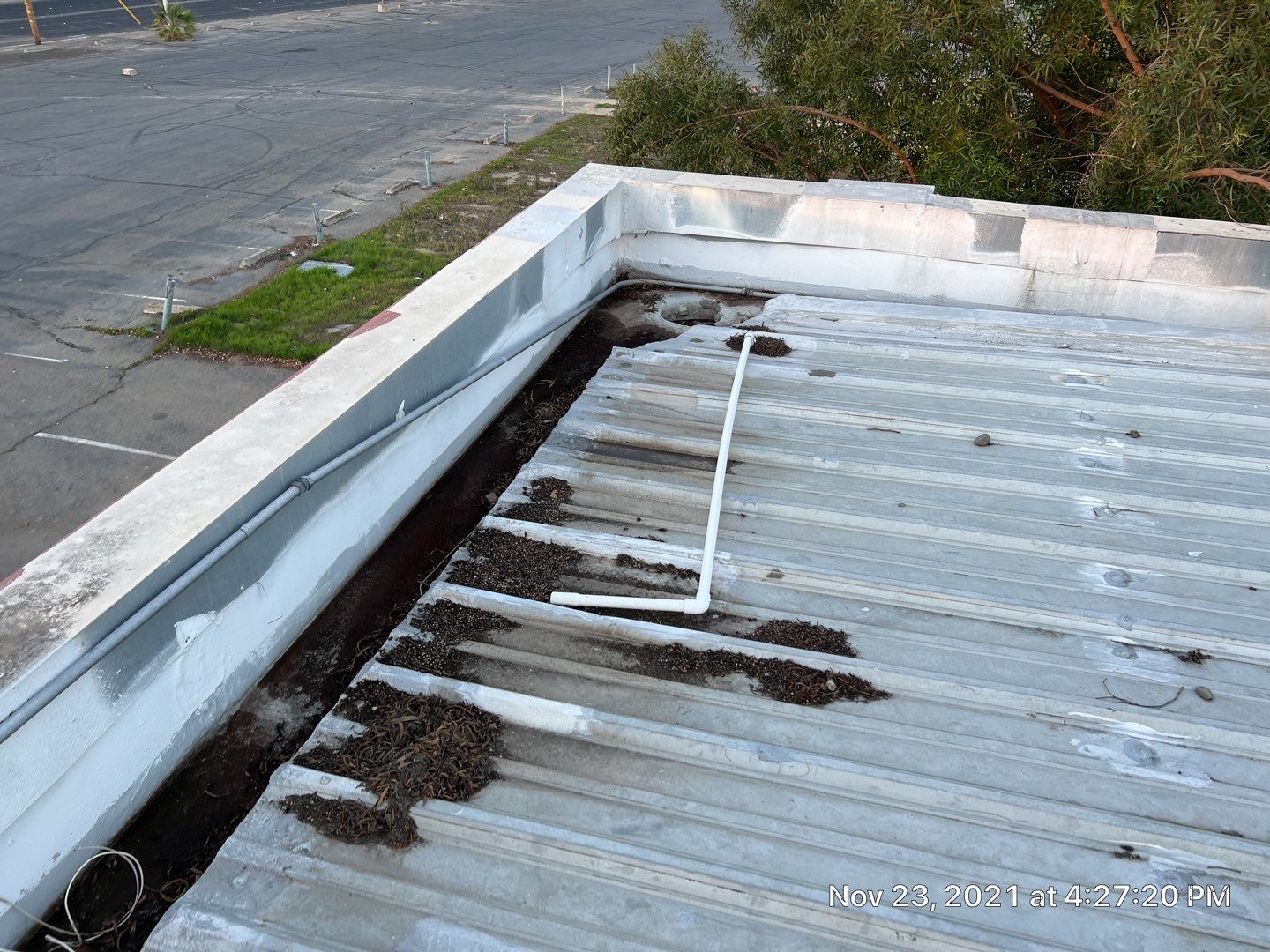 Metal roof restoration on commercial roof using Conklin Benchmark/ PUMA XL acrylic coatings over metal and foam by Straight Edge Roofing Inc