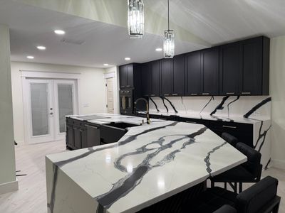Modern Kitchen Remodel in Port Orange Featuring Waterfall Quartz Island