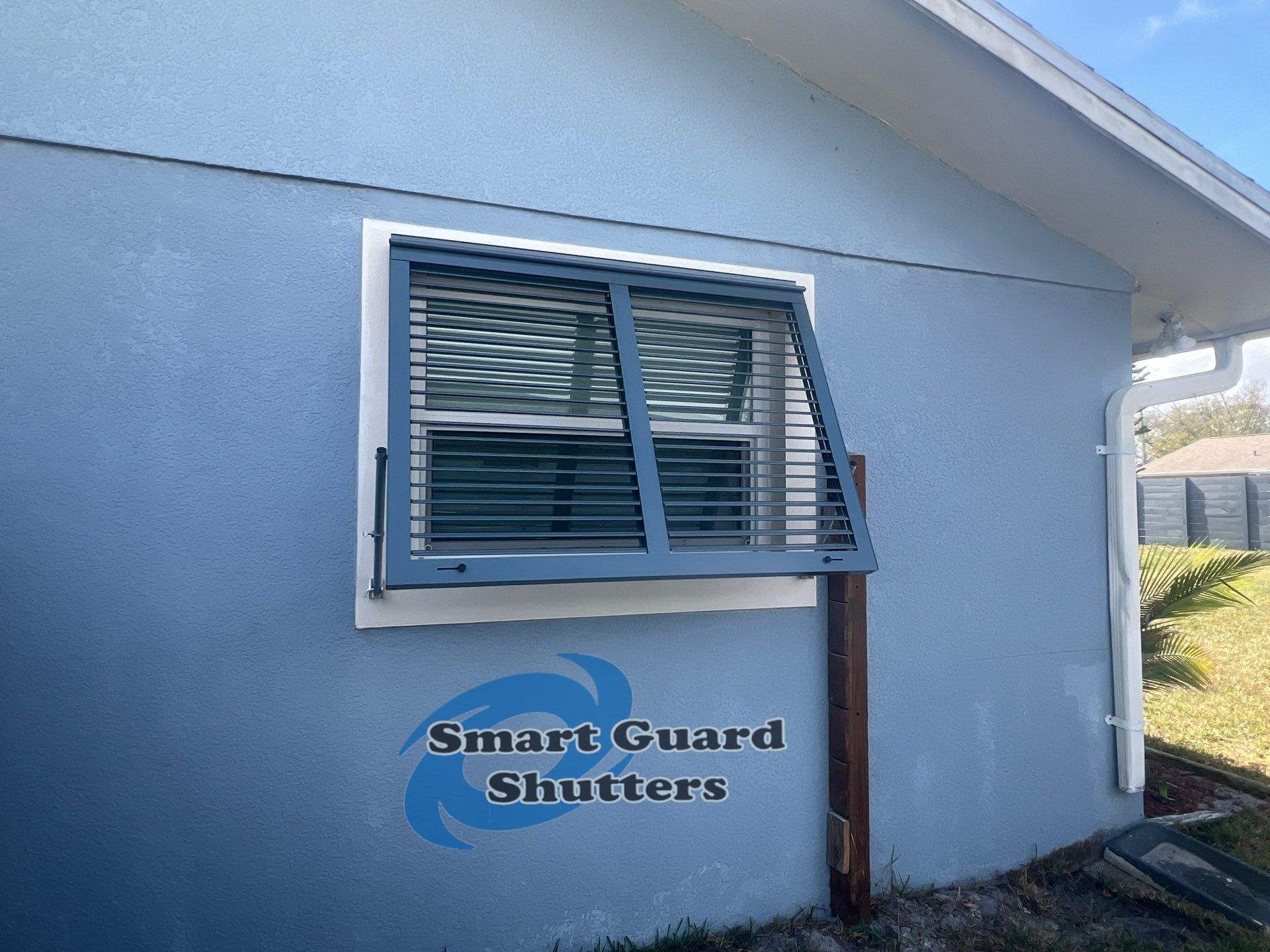 Impact Bahama Shutters in Grey Blue by Smart Guard Shutters