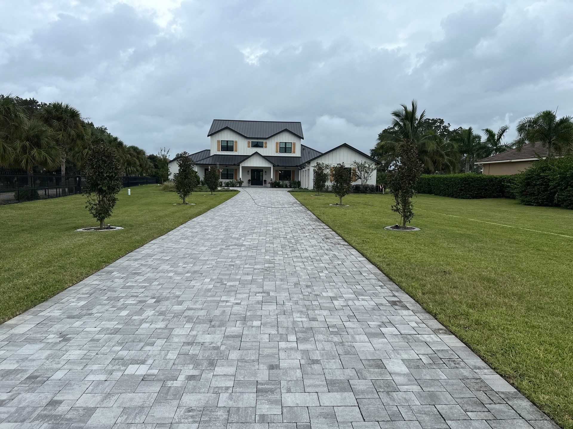 Complete Two-Story House Wash and Driveway Cleaning in Winding River Community, Bradenton, FL by Sunshine AquaWash