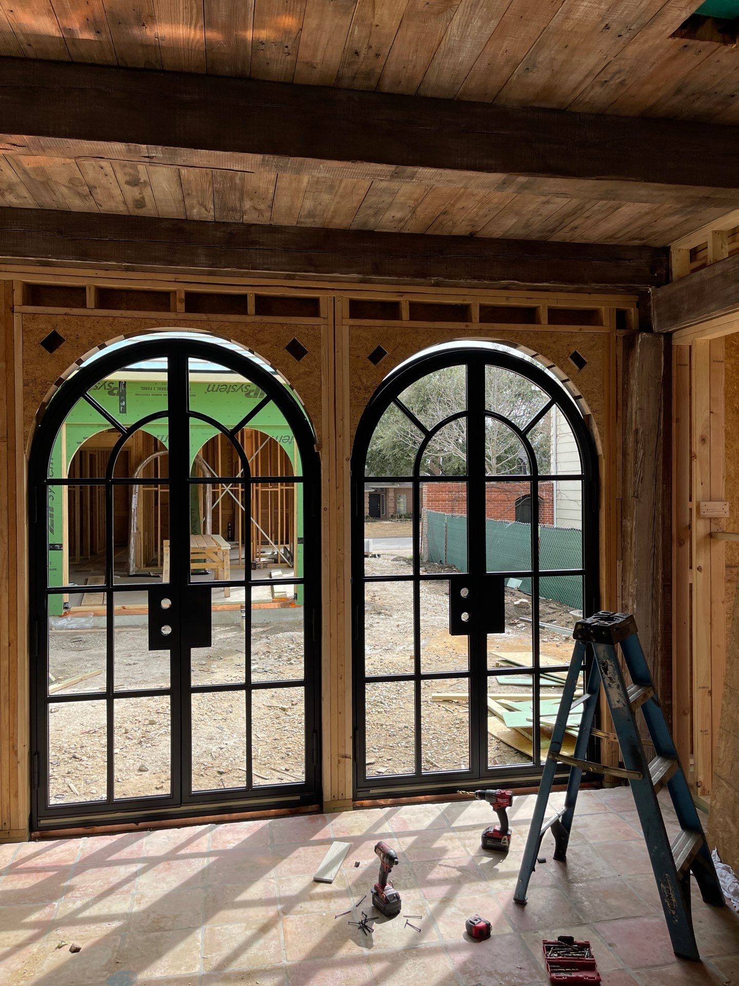 Arched Black Metal French Door Installation and Finishing in Fort Worth by Solara Custom Living